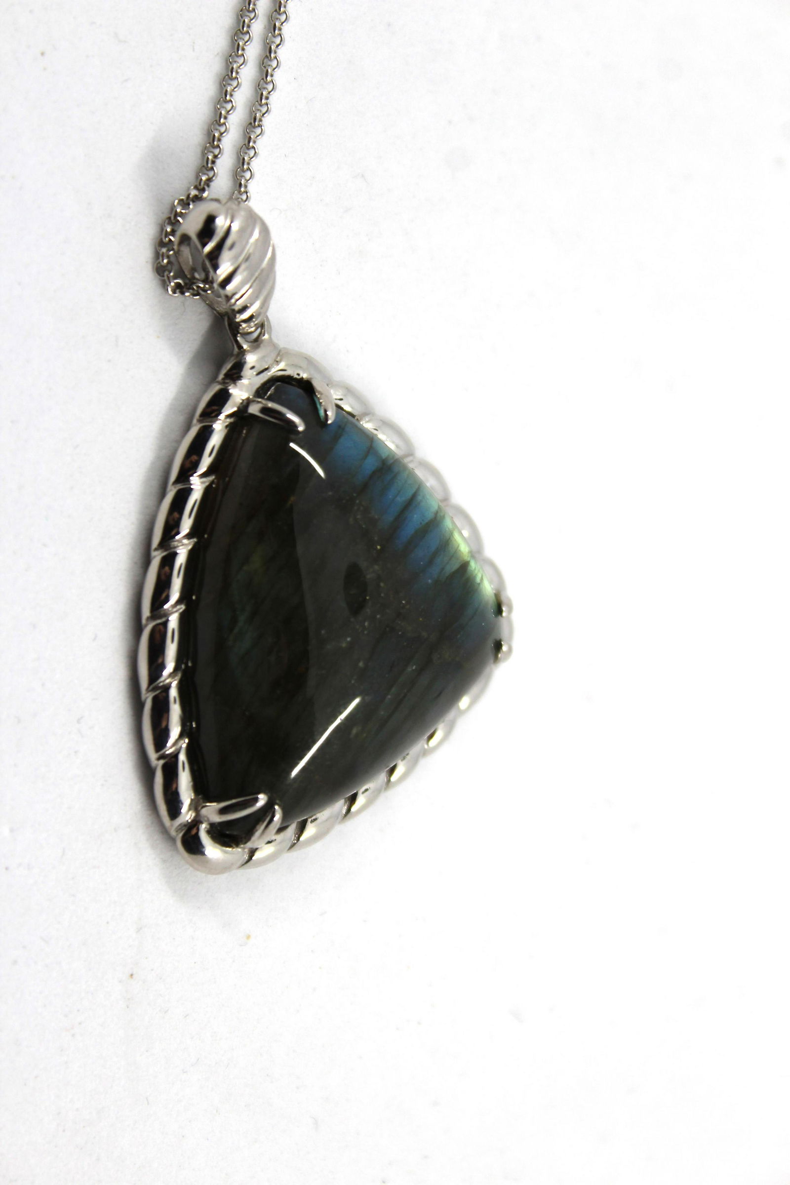 Silver & Labradorite Pendant Necklace: Silver & Labradorite Pendant Necklace Necklace in sterling silver with labradorite pendant. Pendant marked: "NF / 925 / CHINA." Chain marked: "925 / ITALY / BSI". Measures 2.0" L x 1.5" W. Chain is ad