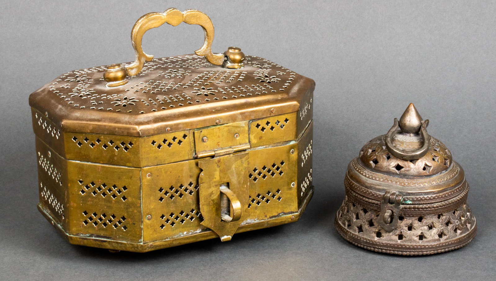 Indian Brass Cricket Box & Incense Box, 2: Indian Brass Cricket Box & Incense Box, 2 Two vintage Indian brass perforated boxes, comprising a footed cricket box and an Hindu incense box, each with hinged lids and handles, the cricket marked to 