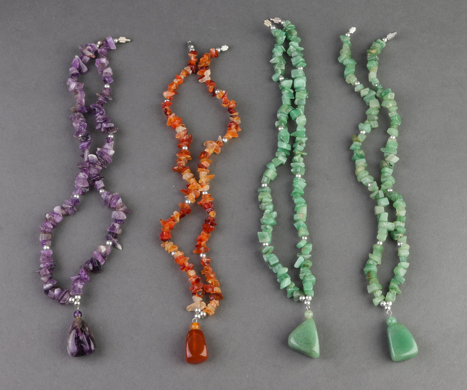 Beaded Aventurine Amethyst & Carnelian Necklaces 4: Beaded Aventurine Amethyst & Carnelian Necklaces 4 Four silver-tone beaded aventurine, amethyst and carnelian necklaces. Aventurine necklaces: 1.75" L x 0.375" W with 1.5" L x 0.875" W and 1.5" L x 0.