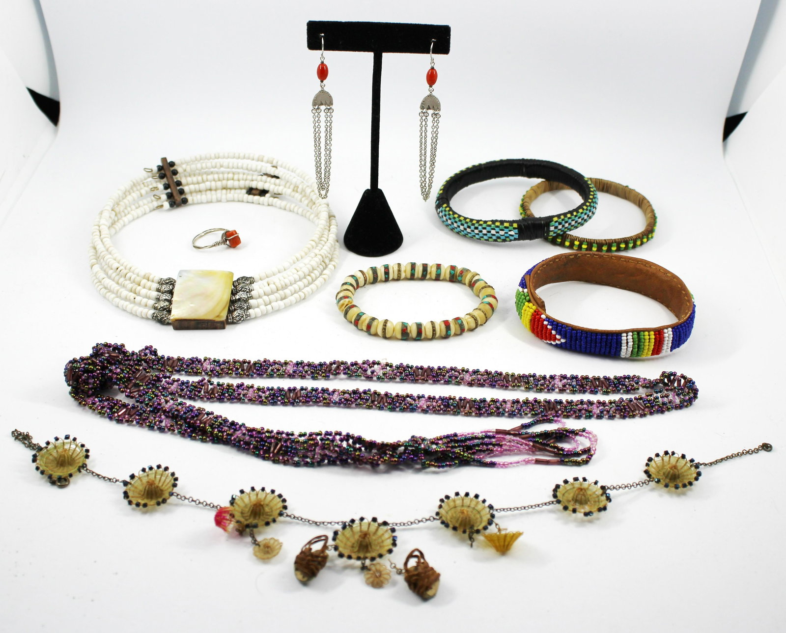 Misc. Ethnographic Inspired Beaded Jewelry: Misc. Ethnographic Inspired Beaded Jewelry Miscellaneous ethnographic inspired beaded jewelry, including three necklaces, four bangle bracelets, a pair of earrings marked "Yosca," and a ring. Largest: