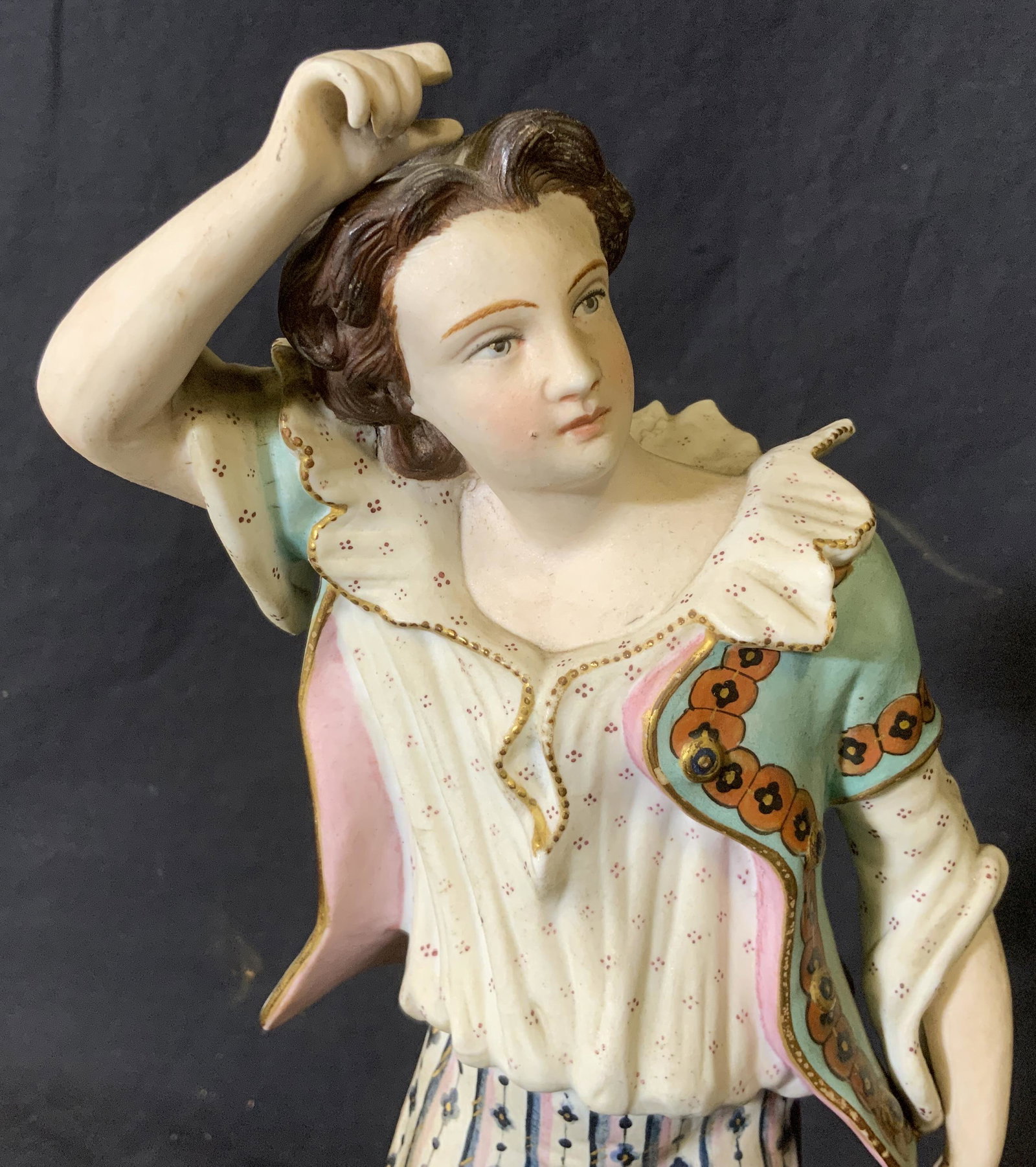 French Rococo Style Porcelain Figural: French rococo style porcelain figural, no apparent inscriptions or markings, subject a male figure in rococo style clothing mid step, some wear and chips to surface, hand painted, measures 14 inches a