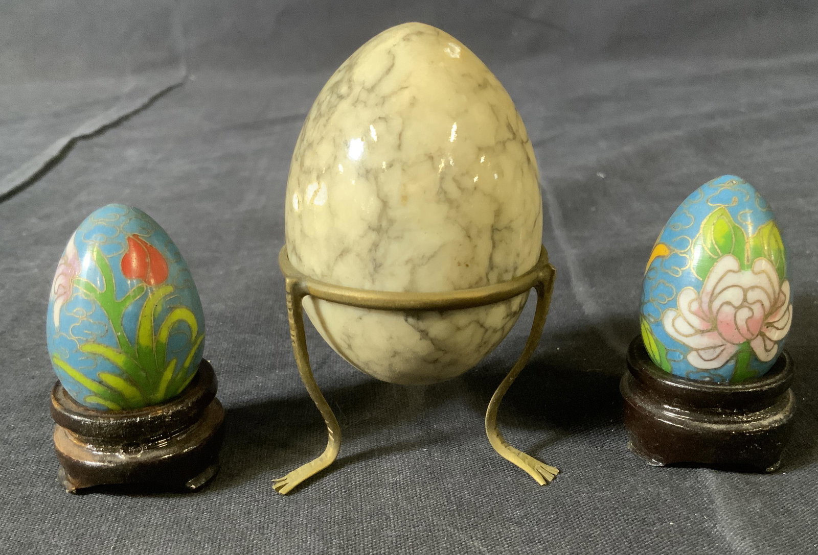 Lot 3 Decorative Stone & Cloisonné Eggs: Lot 3 Decorative Stone & Cloisonné Eggs, inscription to one stand reads ‘Made in China’, largest egg measures 2 3/8 x 1 3/4 inches, smaller eggs measure 1 3/8 inches long, some surface wear to pi