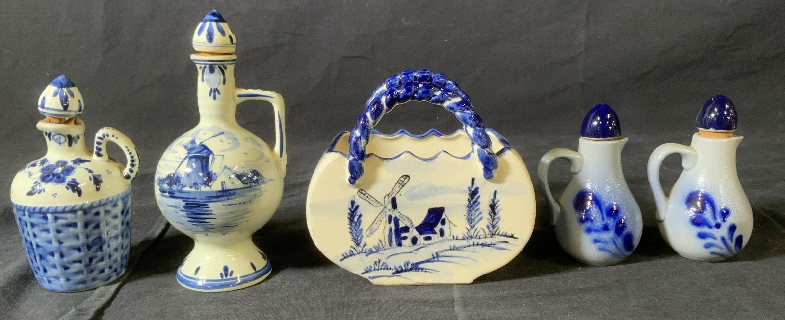 Lot 5 Blue & White Corked Bottles & Dish: Lot 5 Blue & White Corked Bottles & Dish, inscriptions to two bottles reads ‘P Hope Holland Delft Blue Hand Painted’ and ‘O’ and ‘V’, smallest bottles measure 4 x 2 1/8 inches in diameter,