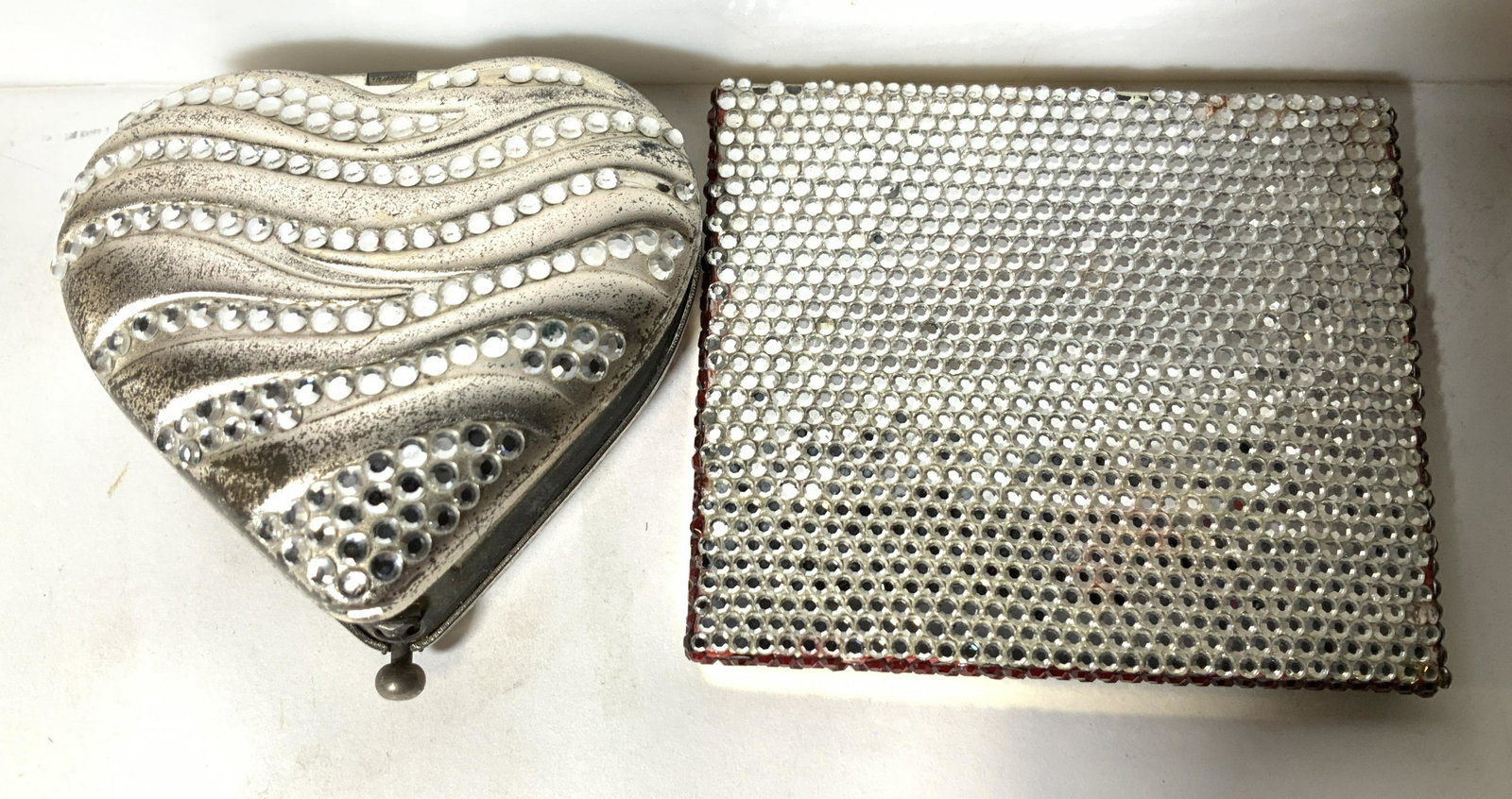 Lot 3 Ladies Compacts & Plated Trinket Bowl: Heart shaped silvertoned and rhinestone mirror compact, needs adjustment to snap closed. Flat micro rhinestone compact labeledmsdeline Beth , backside brushed goldtone metal. Ribbed silver plated lidd