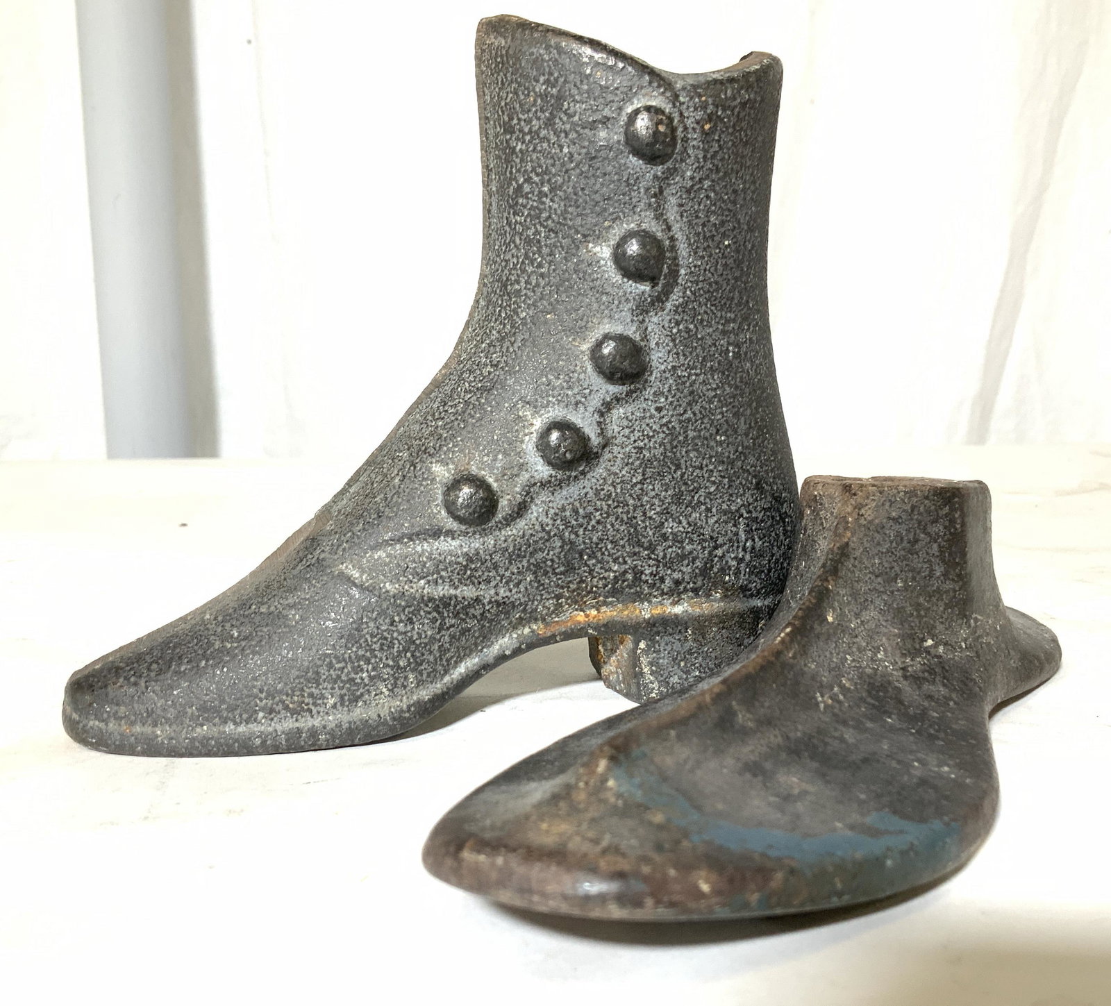 ANTIQUE IRON COBBLER SHOE FORMS, 2: Stylish ladies ‘can can’ boot and flat shoe form, both cast iron antiques. Boot with molded buttons up the side, Boot ht 5.25 in. , 6.25 in L, 2.25 in W. Shoe form 8.5 in. L Antiques, antique iron