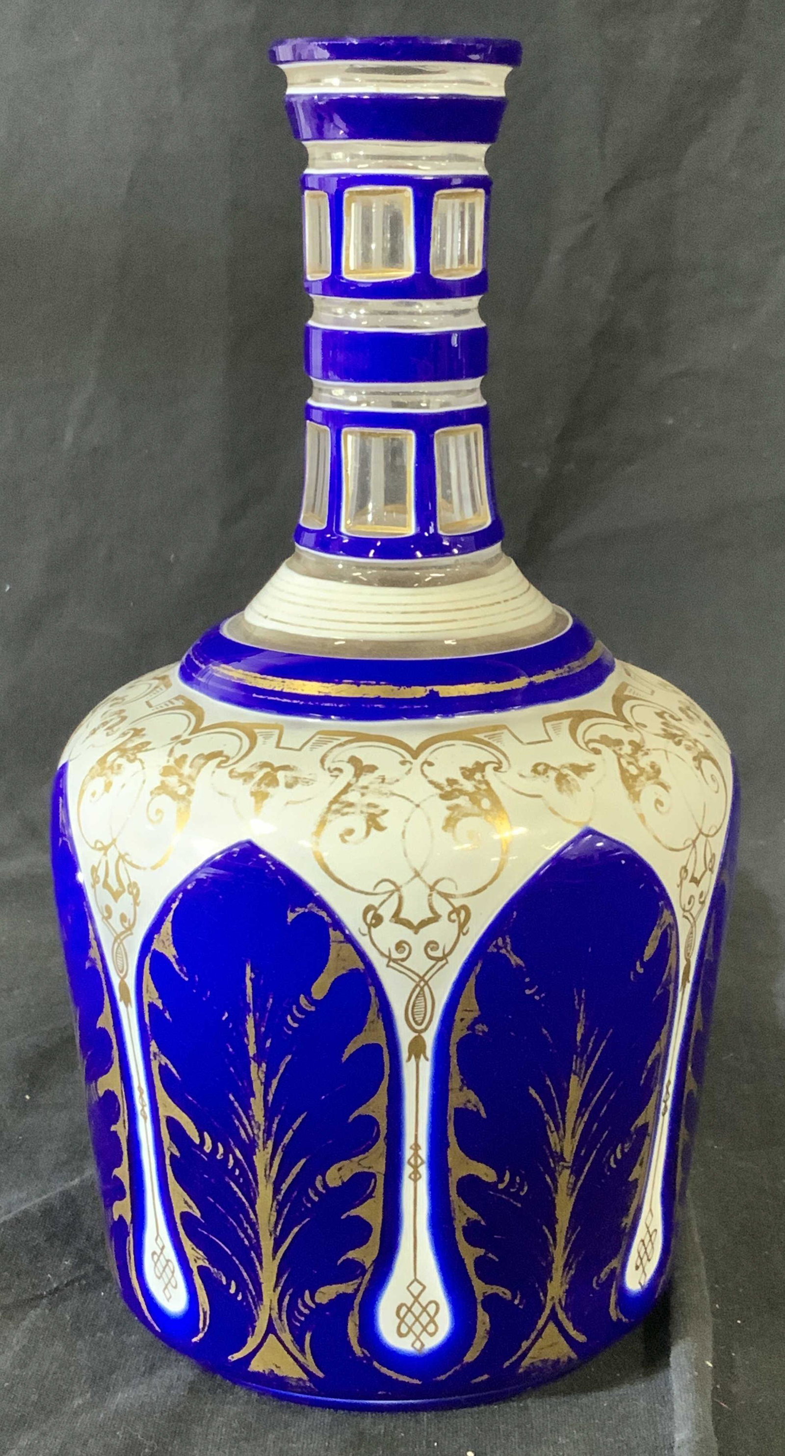 Arabian Pattern Glass Decanter: Cobalt Blue, white with gilt, worn, consistent with age and use, no stopper, vintage hand painted over clear glass. Ht 9 in. Width 5 in. Decanter, Hand painted glass, Arabian pattern decanter, bar war