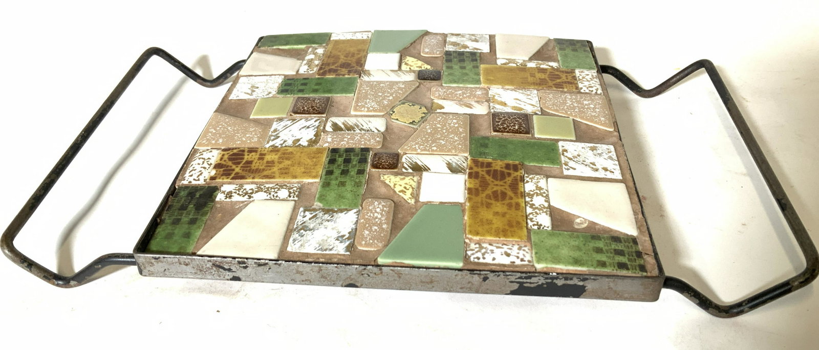 Handmade porcelain mosaic trivet: Colorful porcelain pieces, rounded with geometric shapes, placed into a metal frame with clay and made into a table trivet. Has carry handles , total length 10.25 in. Trivet measures 6 x 6 in. Vintage