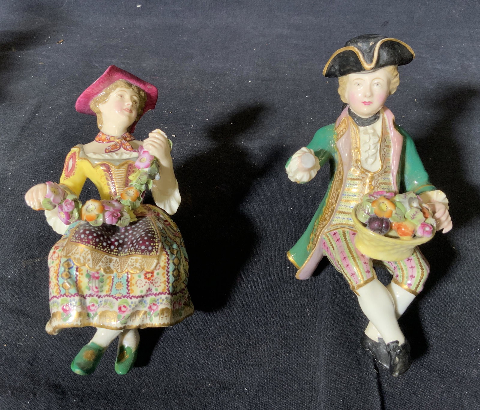 Group 3 German Porcelain Figurines: Group 3 German porcelain figurines, tallest of the three has stamp to underside that reads ‘Sandizel Germany’, tallest figurine depicts a man in French rococo clothing, the other two depicts a man