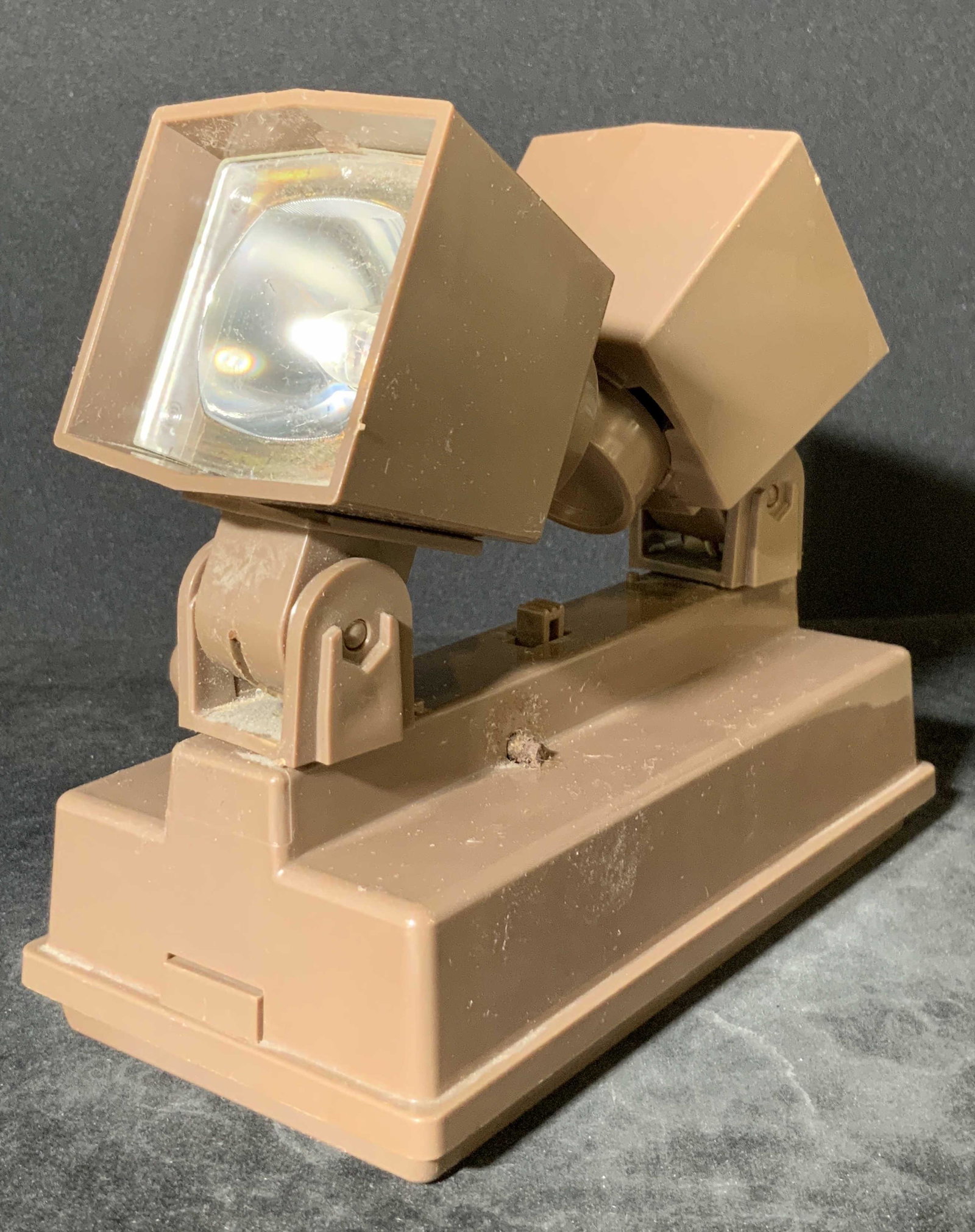 C. 1967 Vintage Tabletop Lighting Fixture: A dual headed vintage lighting fixture. Piece is crafted from brown hued plastics. The light heads are adjustable. Underside reads MADE IN USA, COPYRIGHT 1967, PAT PEND. Not tested for working conditi