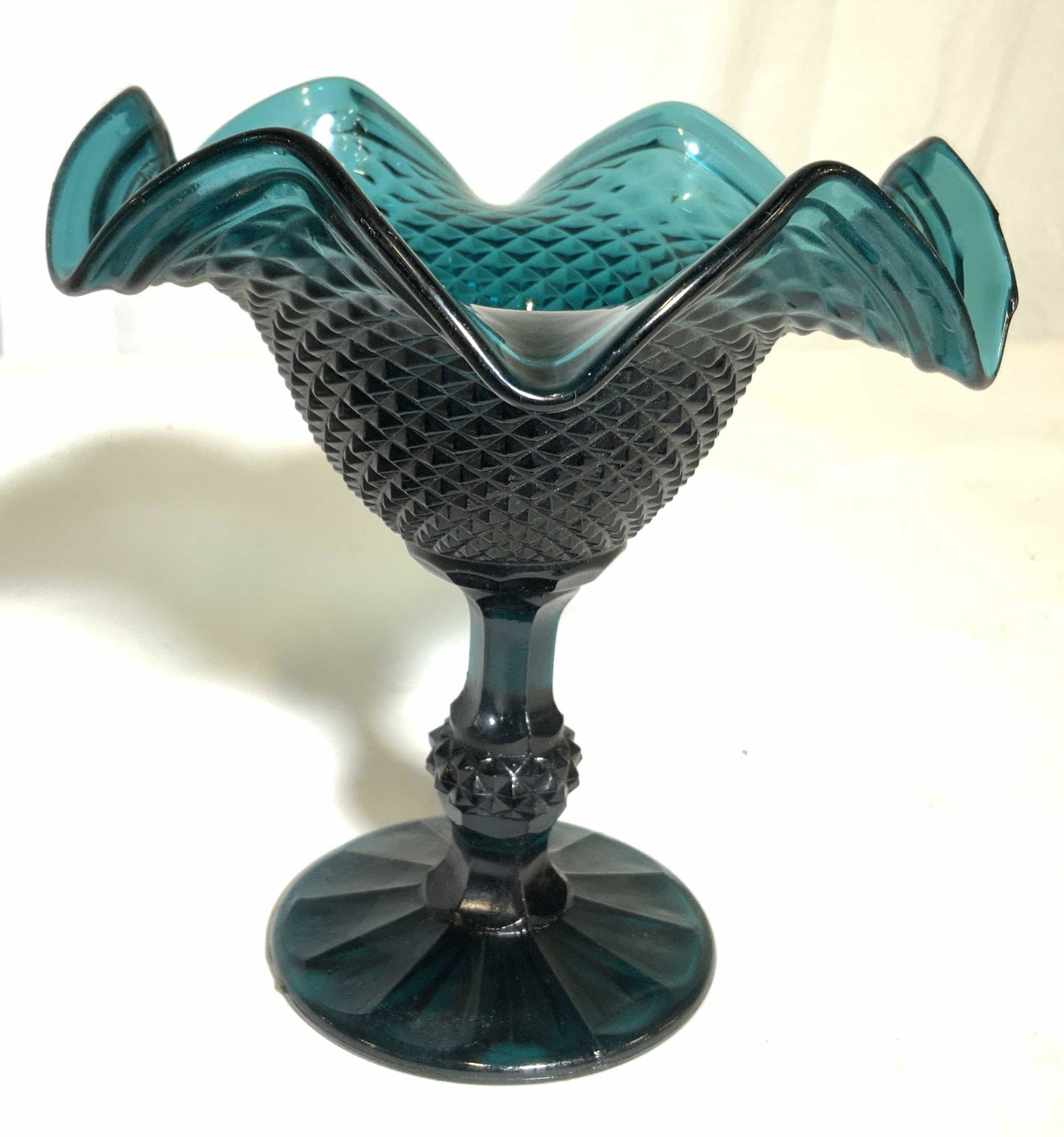 Teal Pedestaled Art Glass Compote Dish: Dish is teal toned and pedestaled. Piece has Diamond shaped relief pattern detail. Piece has frilled rim. Compote dish, candy dish, pedestal Art Glass dish, Art glass, Art Deco. tableware, tabletop ac