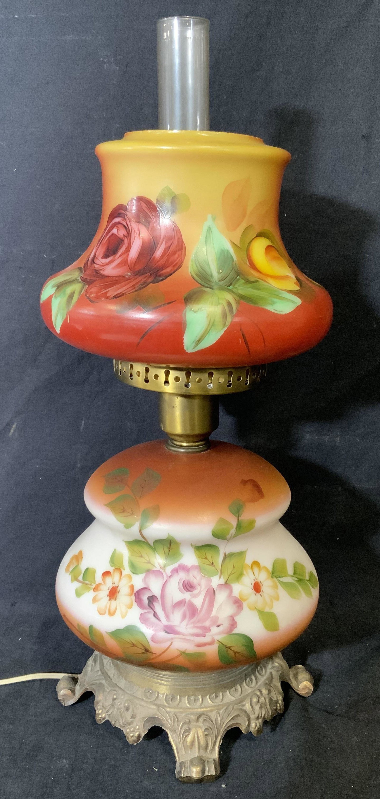 Floral Gone-With-The-Wind Lamp: Floral Gone with the wind lamp, no apparent inscriptions or markings, lamp has two bulbous hand painted glass bodies with a brass toned metal bass, piece measures 19.5 inches at tallest point, piece h