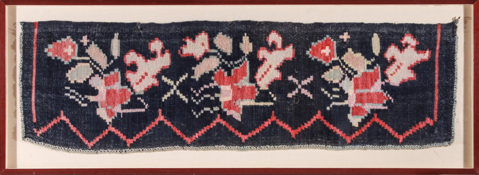 Asian Framed Woven Textile Fragment: Asian woven textile fragment in shadowbox frame, predominantly in blues and reds with a floral motif, mounted on fabric in cherry color frame. Fabric: 15.5" H x 50.5" W; frame: 20.75" H x 56.25" W x 1