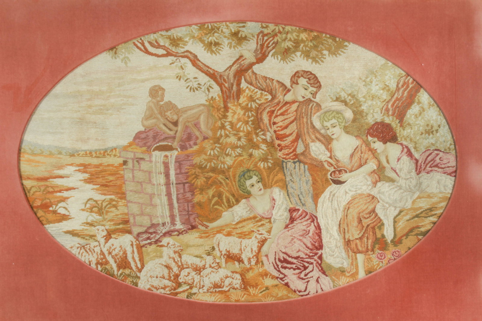 French Rococo Style Needlepoint of Pastoral Party: French Rococo style needlepoint, depicting a pastoral scene of figures beside a well with lambs and putto. Image 27" H x 42.5" W; frame 39" H x 54" W. Fading of color to velvet matting.