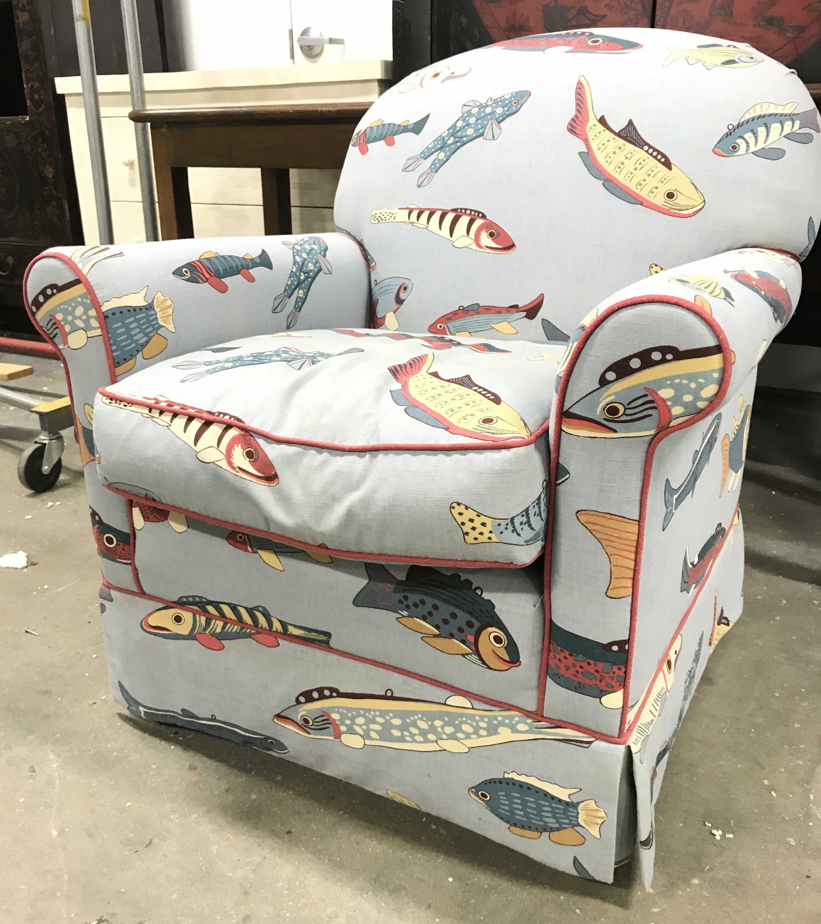 CALICO CORNERS Fish Upholstered Armchair: Underneath cushion has tag which reads CALICO CORNERS CUSTOM FURNITURE. Piece has multi toned fish pattern detail. Armchair appears to be custom made. Piece measures approximately 32 inches tall 30 in