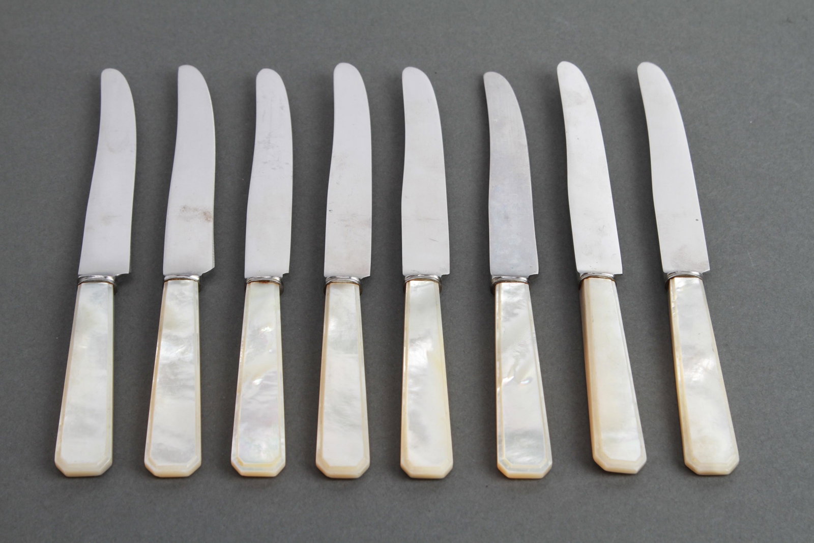 Jospeh Elliot & Sons Mother-of-Pearl Knives, 8: Set of eight Joseph Elliot & Sons hor d'oeuvre knives with carved beveled mother-of-pearl handles, marked on the blades: "Joseph Elliot & Sons/ Stainless Sheffield. 6.125" L.