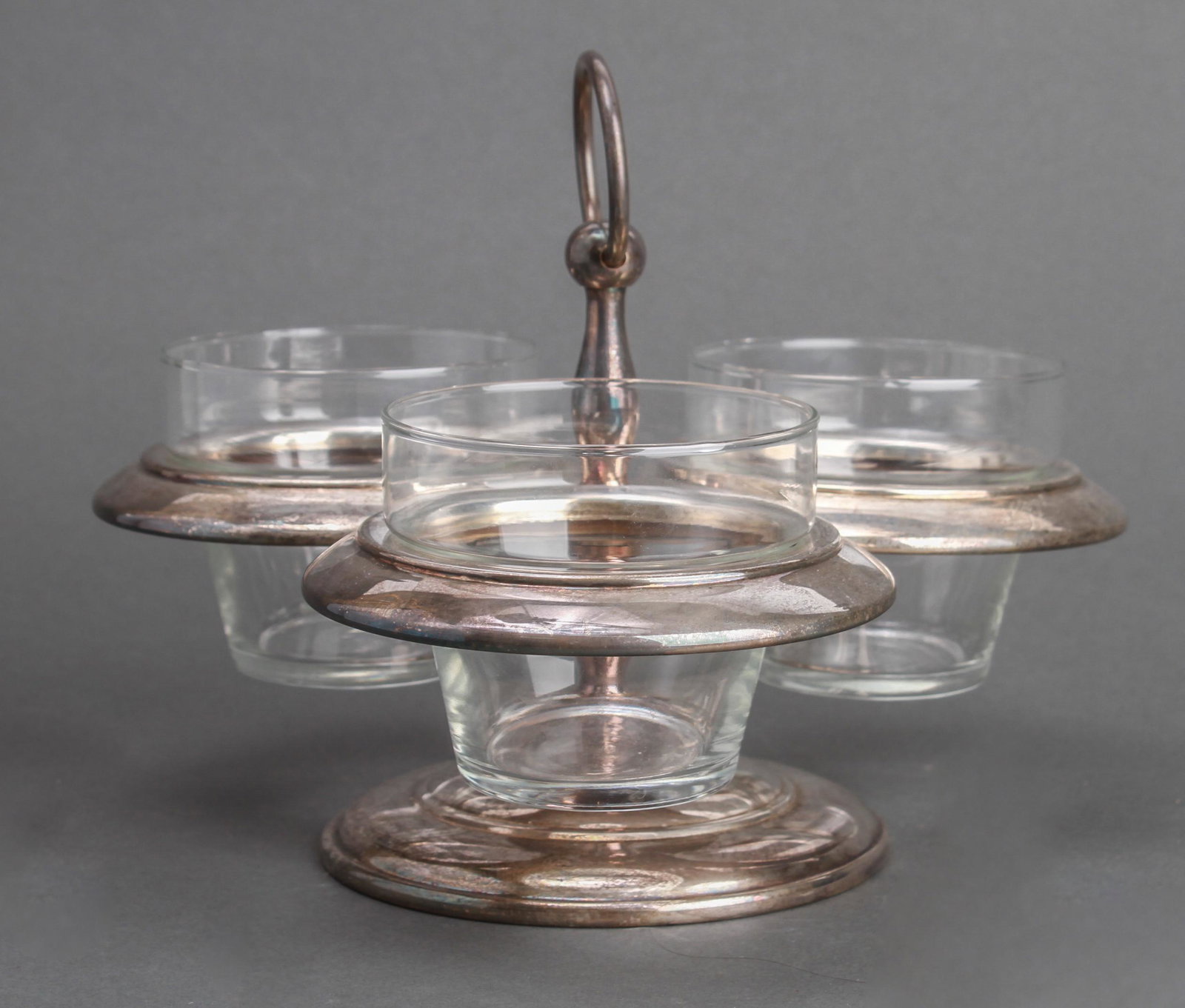 Taunton Silver-Plate & Glass Centerpiece Server: Taunton silver-plate centerpiece or three bowl server with glass inserts, maker's label underside: "Taunton Silversmiths Fine Silver Plate / A Division of Lenox." 7.5" H; bowls: 3" H x 3.5" diameter.