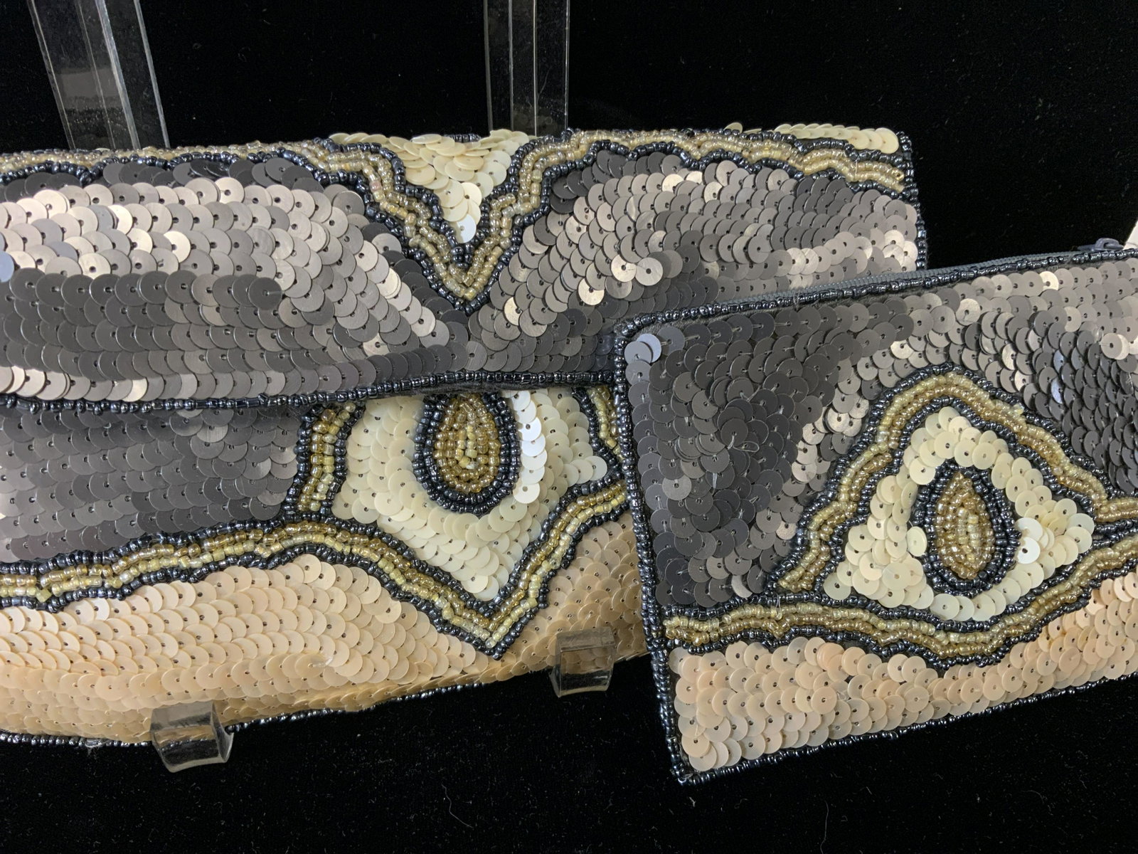 Pr K.C. MALHAN Art Deco Sequined Clutch Purses: 2 pcs. Designer labeled Art Deco Clutch/ Wristlet and Change/ ID Wristlet. Appears never used. Both have beaded straps for wrists. Metallic Grey rayon lining. Made in India. Larger measures 10.5 x 6 i