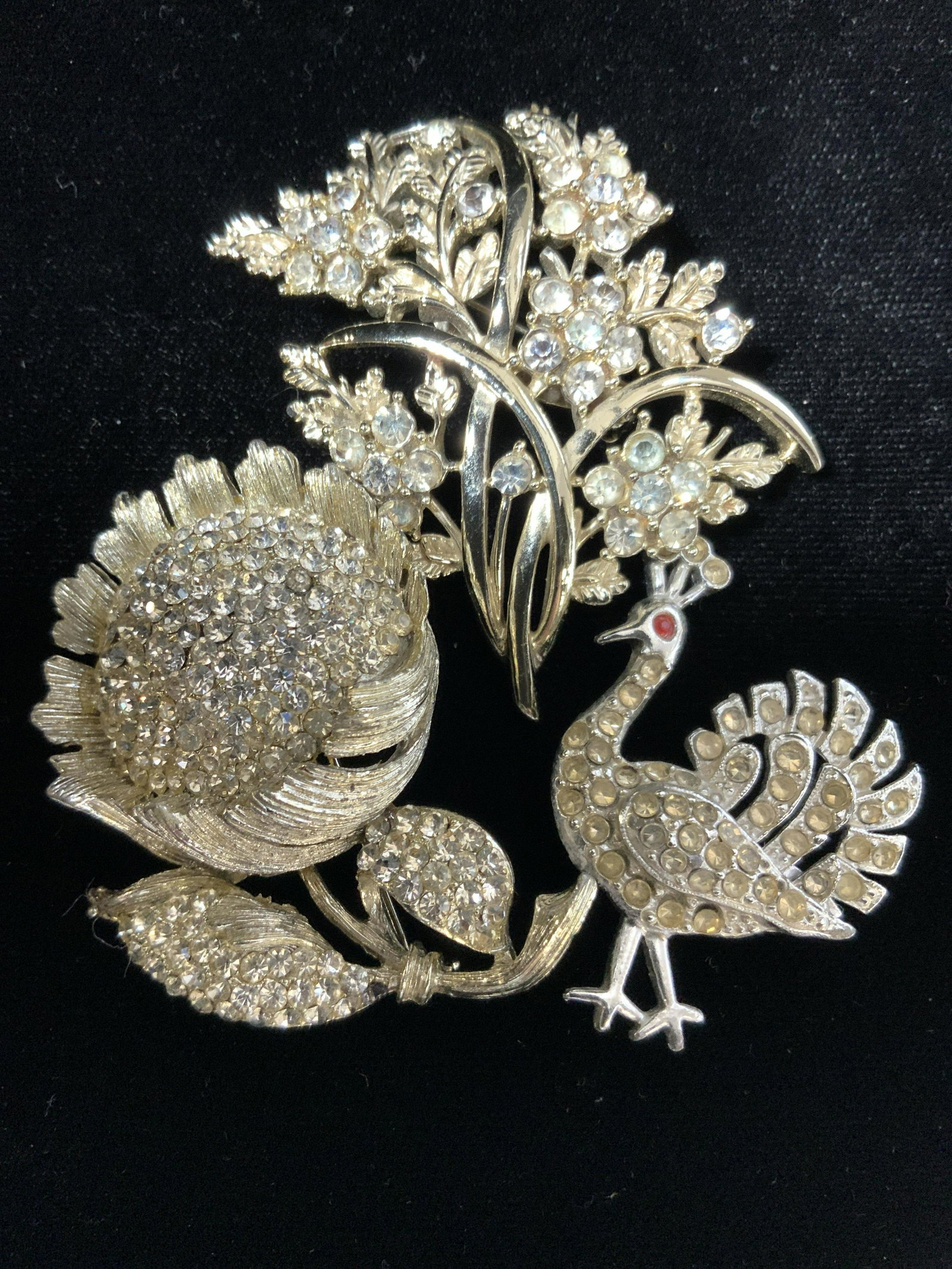 1930s PEACOCK, SUNFLOWER & Nouveau Brooch, 3: Lot 3 Vintage brooches, all rhinestone in white metal. Asian Peacock with red Ruby rhinestone eye, couple missing stones, dates c. 1930s Art Nouveau period, 1.5 x 1.25 in. Diamanté encrusted sunflowe