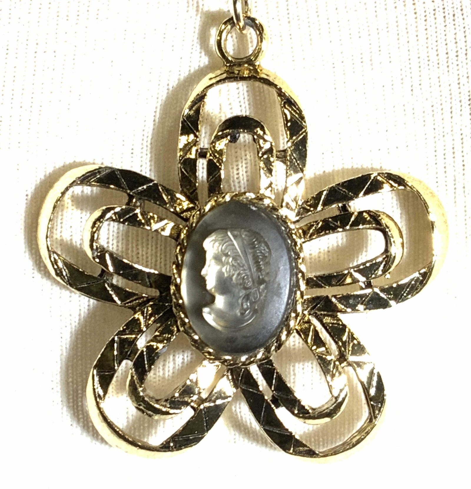 Cameo Center in Flower Pendant Necklace, Jewelry: Modern Style Jewelry with luminescent carved lucite cameo in relief. Open work flower power 60s style daisy pendant , 2 in diameter. 22 in chain with spring ring. Cameo pendant, modern style cameo jew