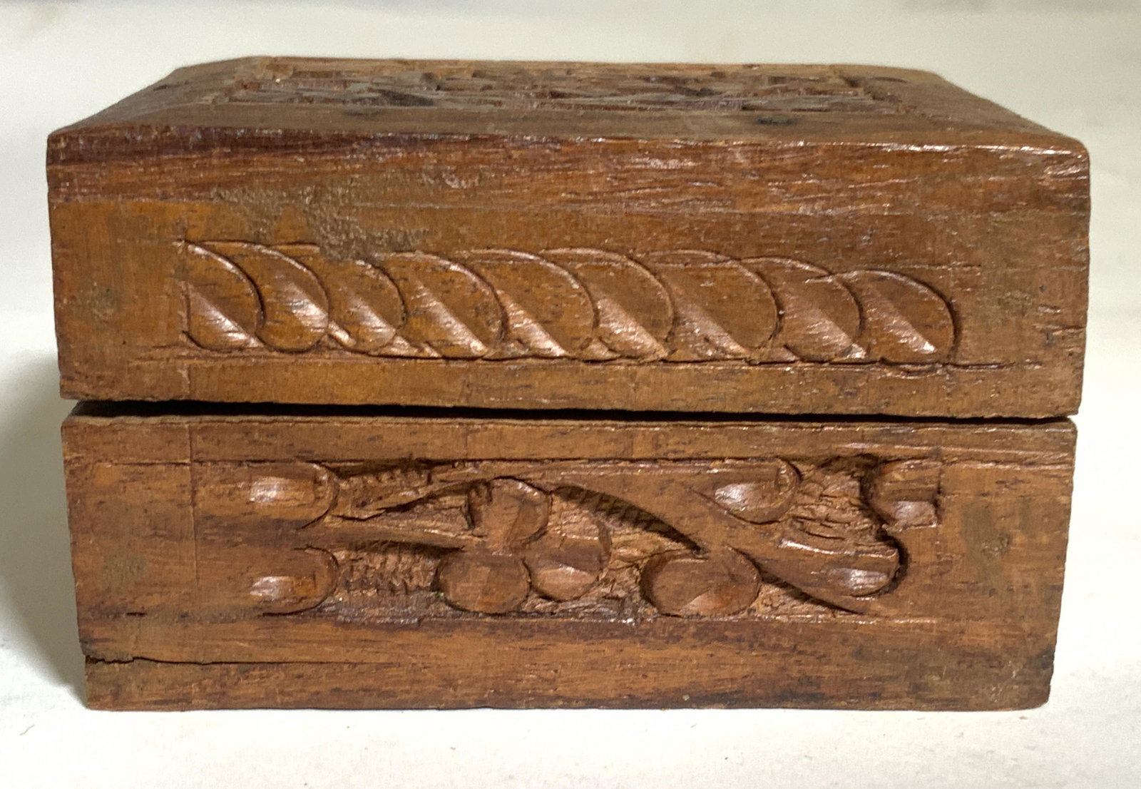 Vintage Hand Carved Wooden Trinket Box: Trinket box is vintage. Piece appears to be hand carved. Piece contains carved floral and leaf detail. Piece measures approx 3 inches long 2.5 inches deep 2 inches tall. Trinket box, wooden trinket bo