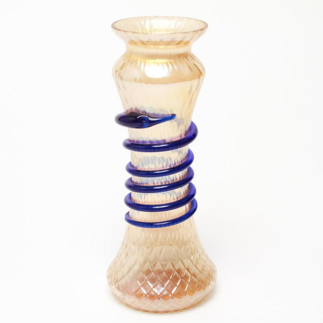 Loetz Manner Bohemian Czech Art Deco Snake Vase: Loetz manner Bohemian Czech Art Deco hand-blown iridescent peach and gold martele glass vase with coiled cobalt blue snake, the underside with a ground-out pontil mark. 9.5" H.