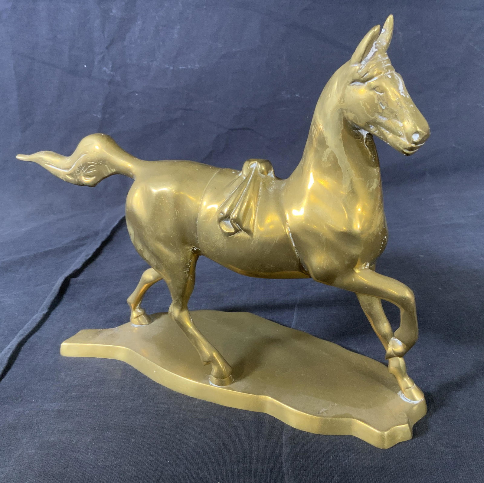 Brass Sculpture of Horse, Decorative Figural: Brass Sculpture of Horse, inscription to base reads ‘Made in Taiwan’, subject a horse mid trot, measures 8 5/8 inches tall x 11 inches at widest point, some surface wear and discoloration to metal