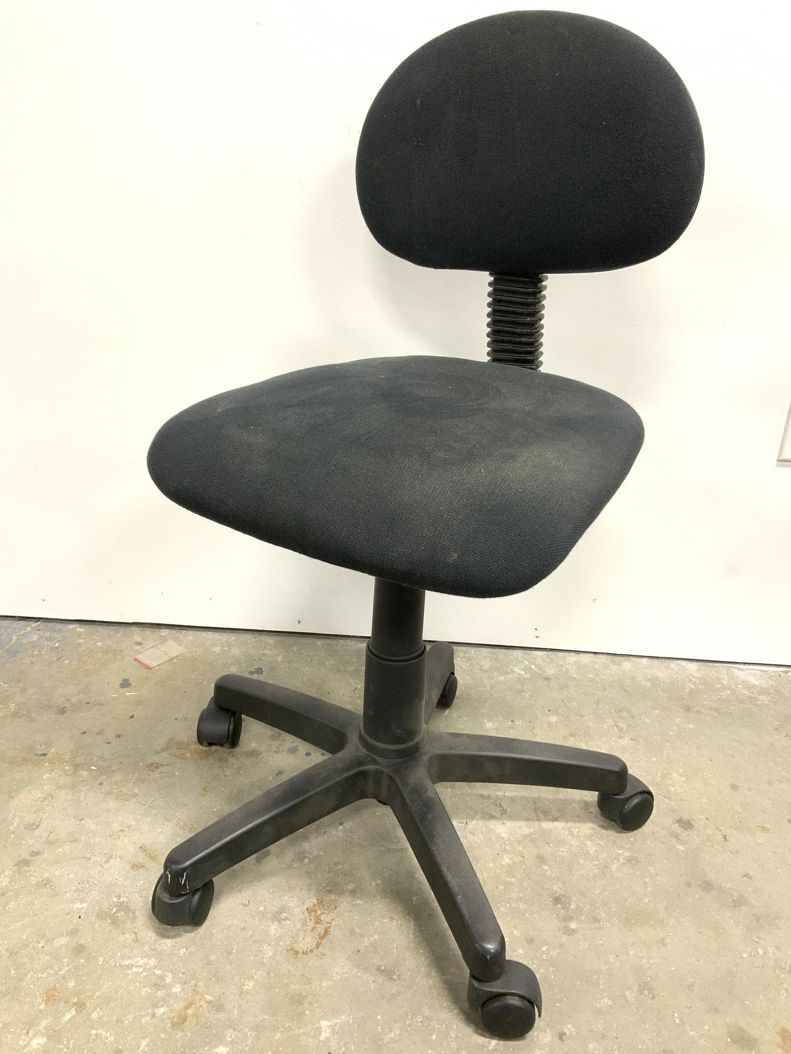 Upholstered Computer Chair On Wheels: Computer Chair is black toned. Back rest & seat are upholstered. Chair sits on 5 wheels. Chair appears to be adjustable. Piece measures approx 35 inches tall 17 inches wide & deep. Computer chair, off