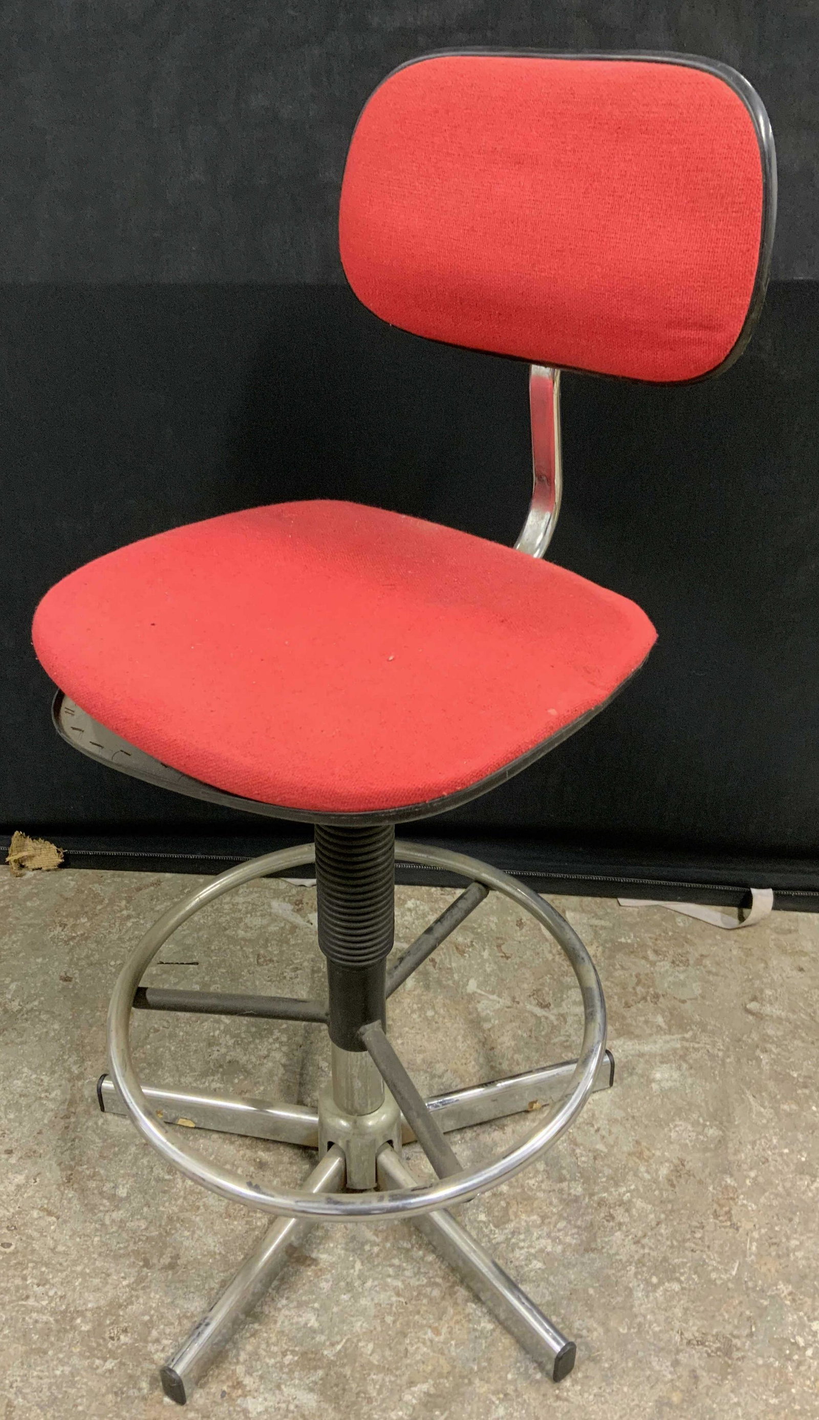 Vintage Red Swivel Chair: Vintage red swivel chair. Chair is upholstered with red fabric, trim on underside needs to be reattached, staples have come loose. Measures approx 38.25 inches H x 17.5 inches W. Wear is consistent wi