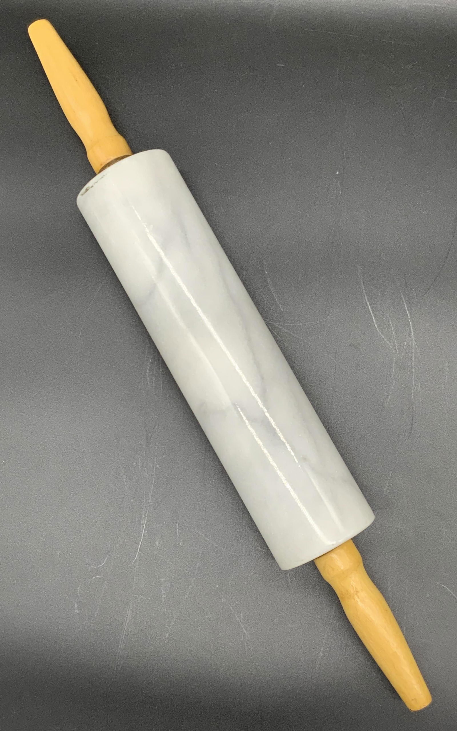 Marble Rolling Pin W/ Wooden Handles, Kitchenware: A marble rolling pin with wooden handles. Some wear consistent with use. Approx. 18L x 3W in. Piece is weighty. Property of NYC Manhattan Estate. Kitchenware, kitchenalia, marble rolling pin, marble k