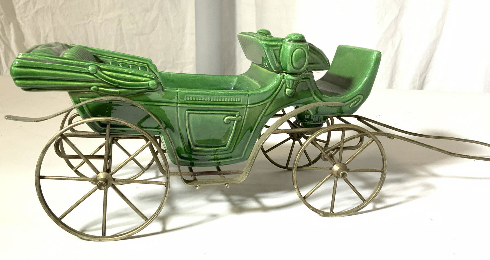 Glazed Ceramic Coach Car On Brass Frame: Handmade porcelain Victorian coach , glazed sold green and fit into a brass coated coach frame specially made for porcelain piece. Perfect to dress up for holidays with figurines and decor. Frame 17 i