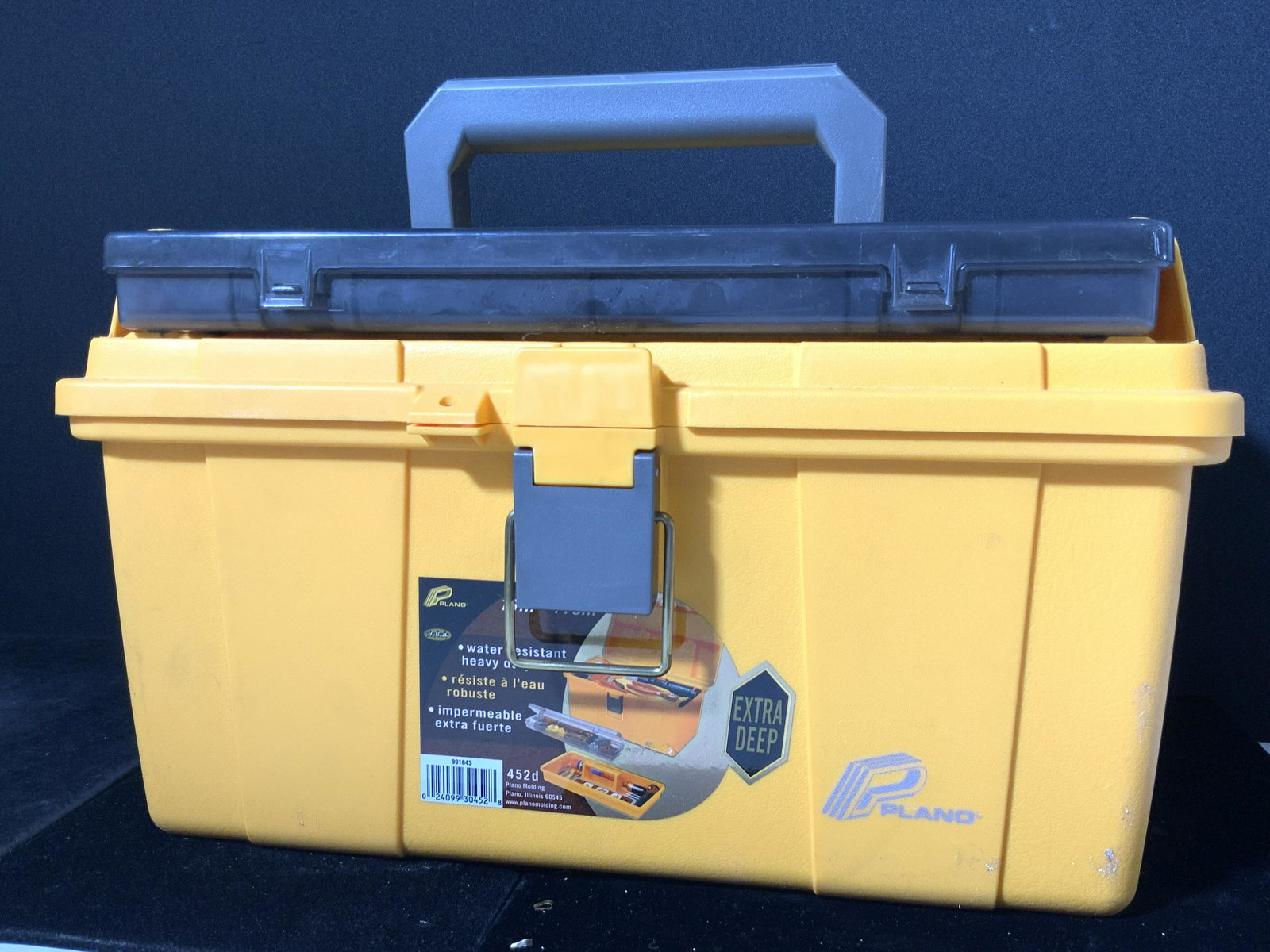 PLANO Extra Deep Yellow Composite Tool Box: A tool box crafted from yellow composite material. The sticker reads PLANO, EXTRA DEEP Approx. 9H x 16W in. The lid features a ruler. Some wear to the tool box. The interior of the box has a removable