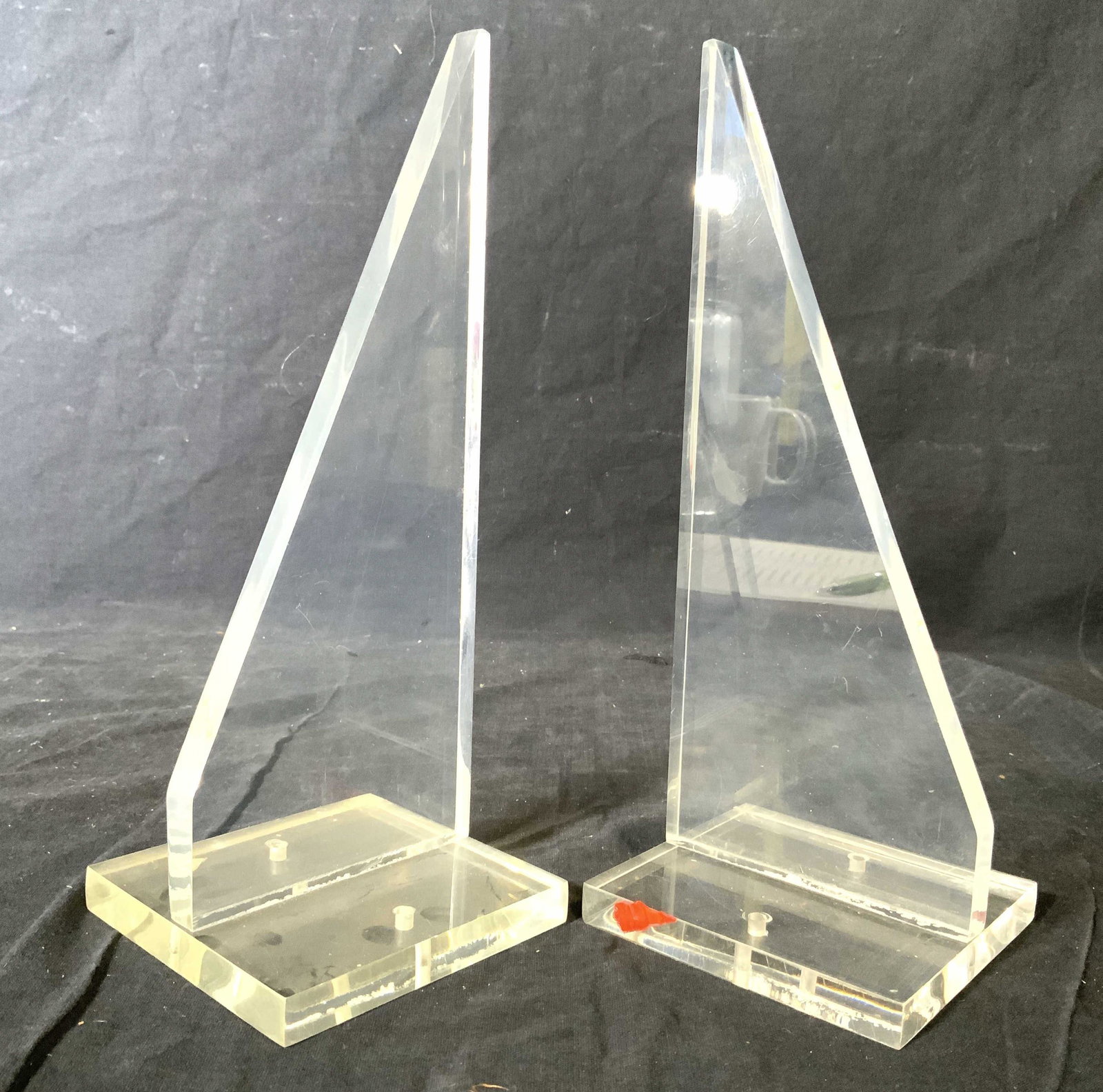 Pair Lucite Bookends W Square Bases: Lot includes 2 bookends. Each are lucite. Both pieces has square bases & pointed tops. Each measures approx 10 inches tall 4 inches square at base. Bookends, lucite bookends, pair of bookends, decor, 