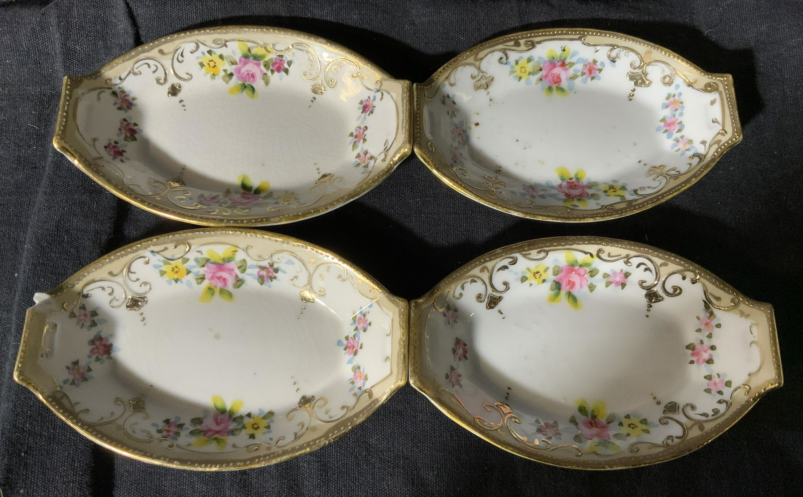 4 Gilt Japanese Porcelain Tea Bag Dishes: 4 gilt Japanese porcelain tea bag dishes, back of each has a stamp that reads ‘Hand Painted Nippon’, each dish is white with gilding and floral designs to the rims, each has varying wear and chips