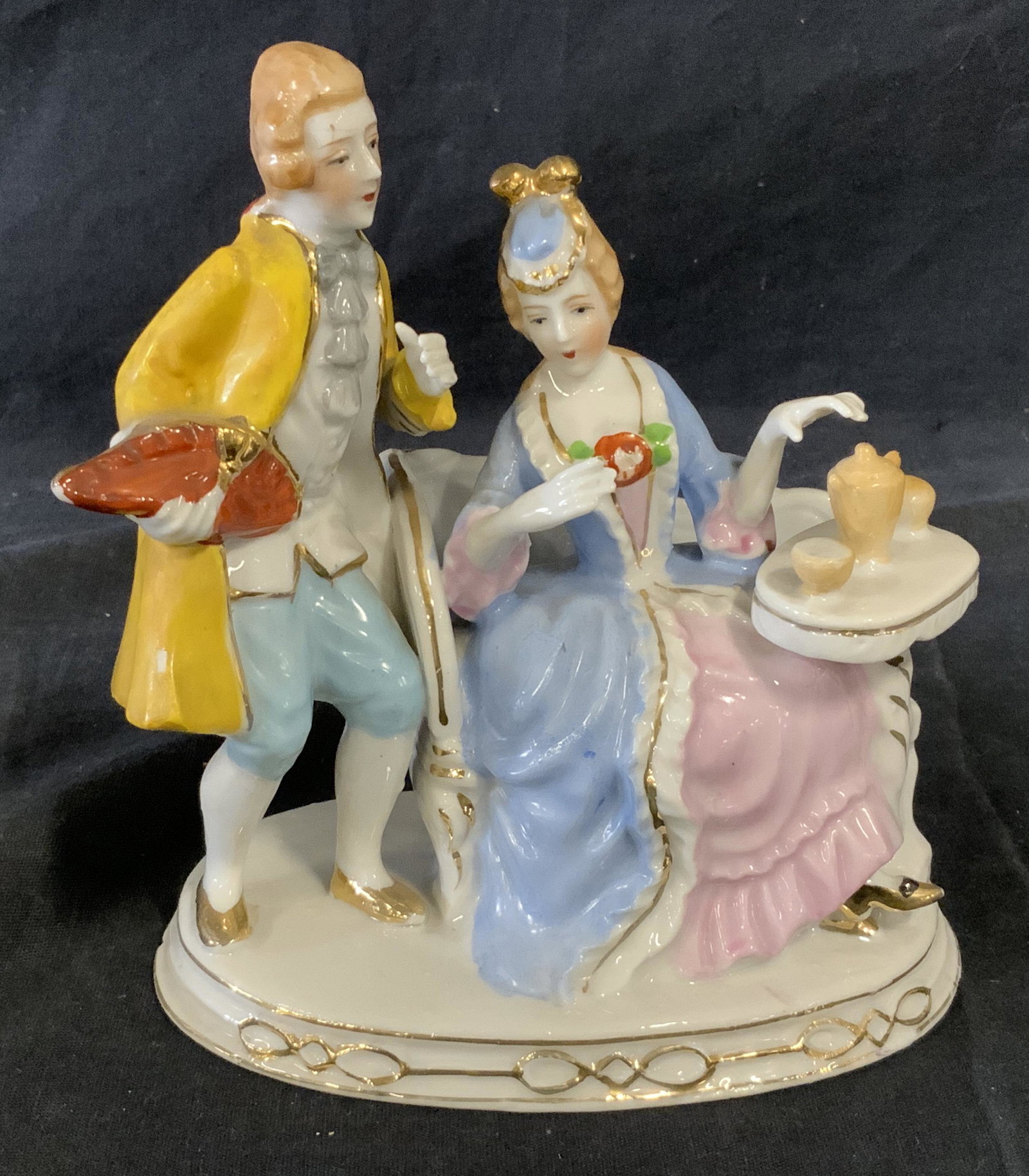 Japanese Porcelain Figural: Japanese Porcelain Figural, stamp to underside reads ‘Made in Japan’, subject a male and female figure in rococo style drinking tea, piece measures 6.5 inches tall by 5.5 inches wide, some wear to