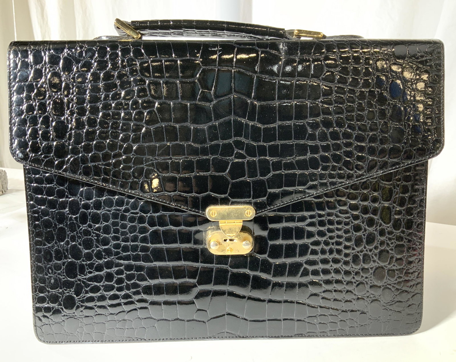 RALPH Lauren Croc Style Briefcase Folder Holder: Black croc pattern, possibly pvc, interior Hallmarked Ralph Lauren on fabric, snap closure with push release button, open compartment with flat pocket under flap. Measures 14 in. L, 10.25 in. Ht, 2.5 