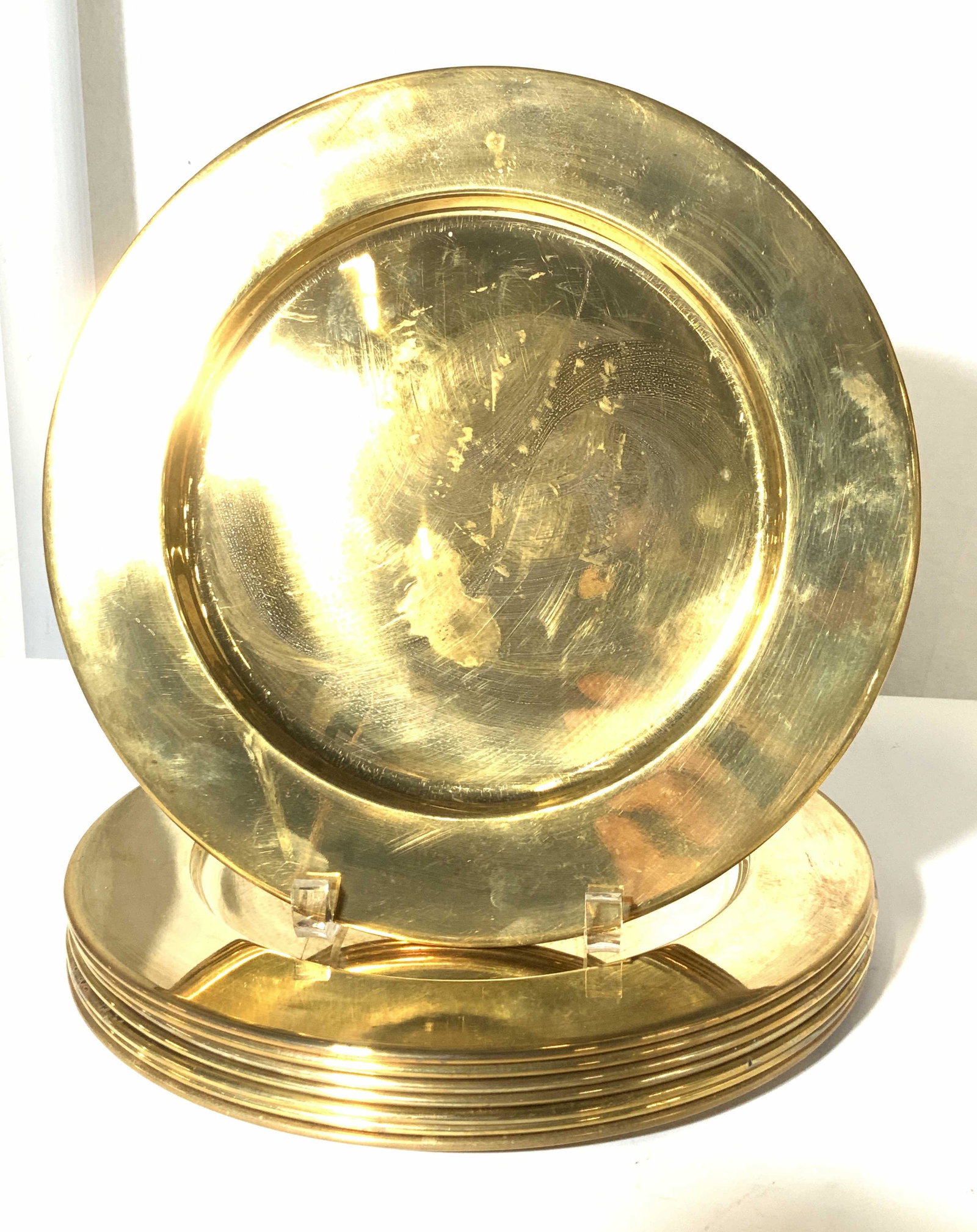 Set 10 VNTG BRASS TABLE CHARGERS: 11.5 in. Brass table chargers, some with light blemishing consistent with age, exposure and use. Minimalist design. Property of Manhattan Estate. Tableware, brass table setting chargers, dinnerware de