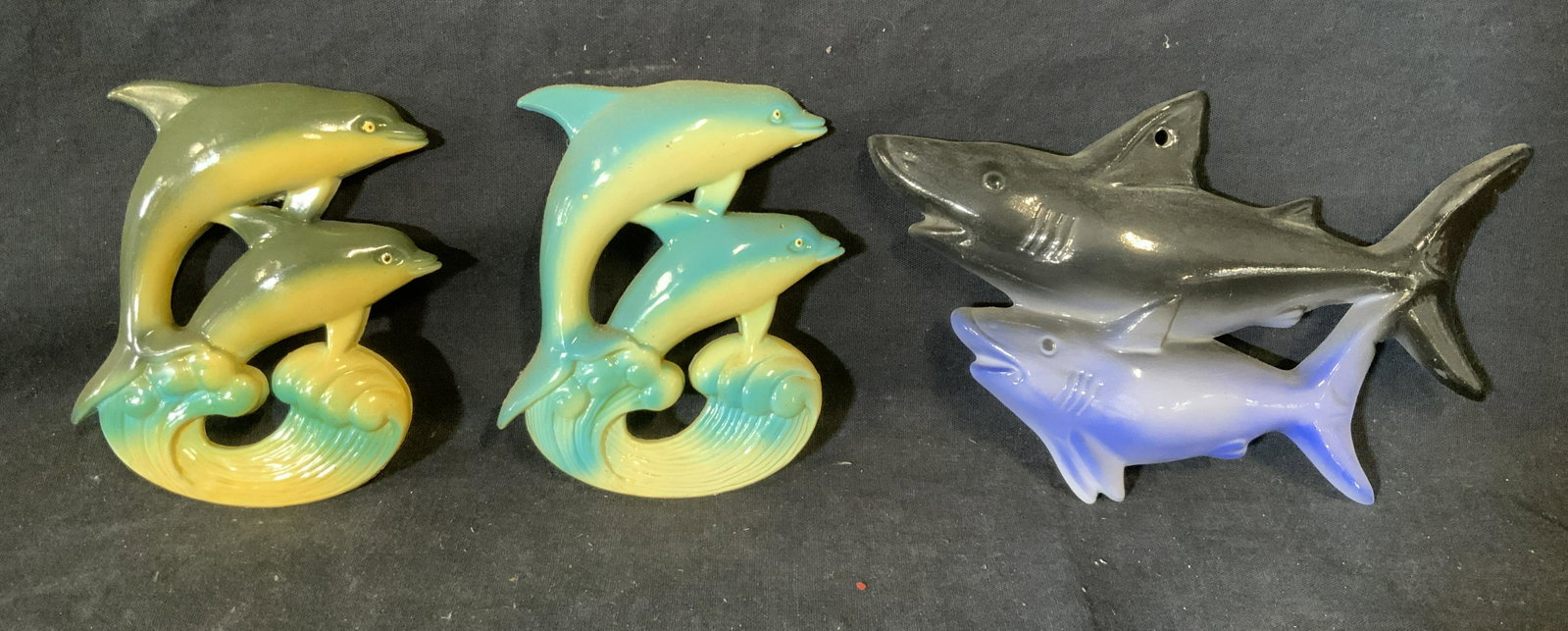 Group 3 Shark & Dolphin Wall Mount & Magnets: Group 3 shark and dolphin wall mount and magnets, two composite dolphin piece with magnets, sharks made of ceramic, all are hand painted, largest piece of group measures 7.5 inches long and 4.5 inches