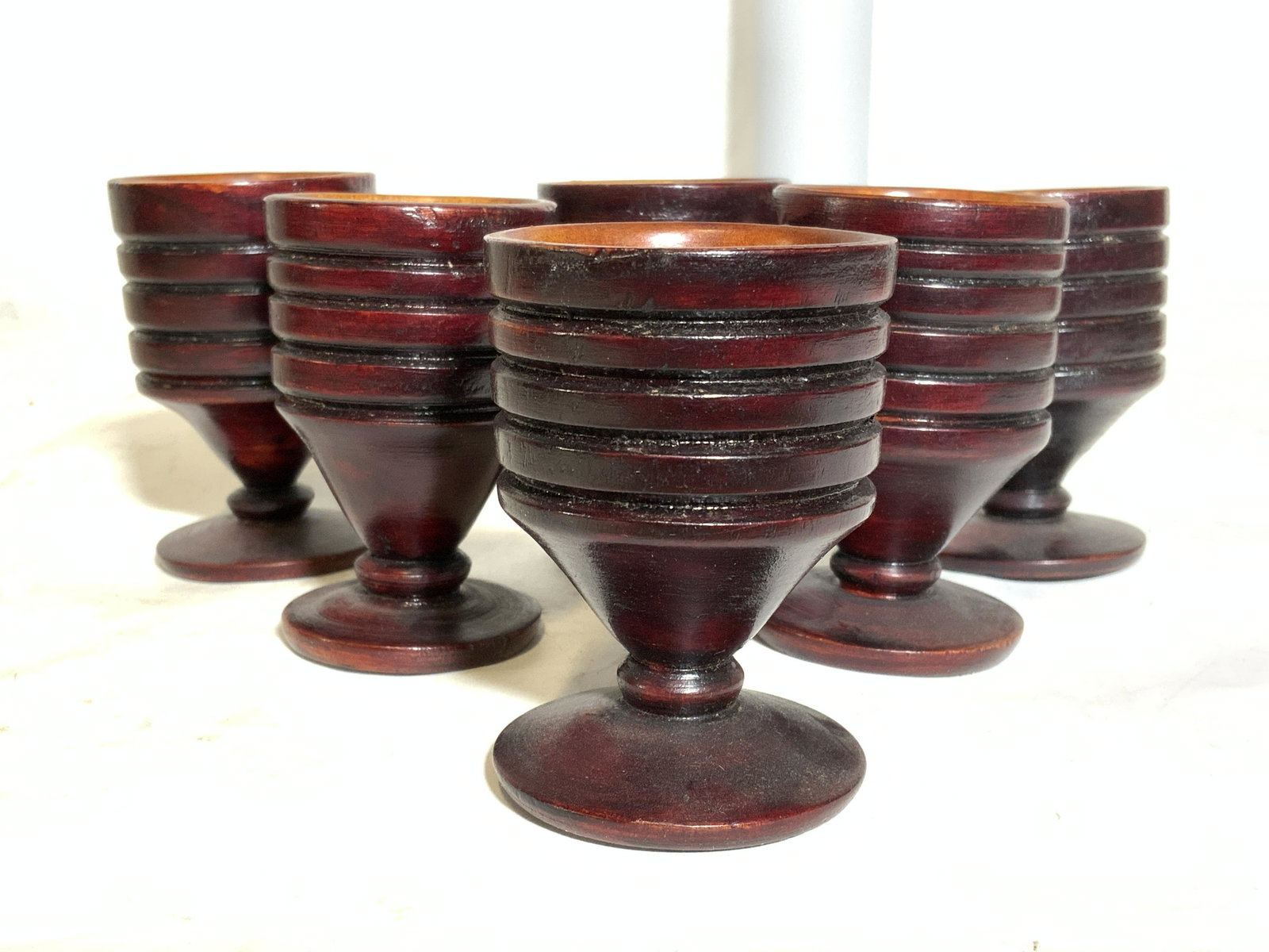 Set 6 Vintage Carved Wooden Egg Cups: Lot includes 6 egg cups. Each have stems and are wooden. Each have line relief detail around sides. Each measures 3 inches tall 2 inches wide. Vessels, set of vessels, egg cups, wooden egg cups, kitch