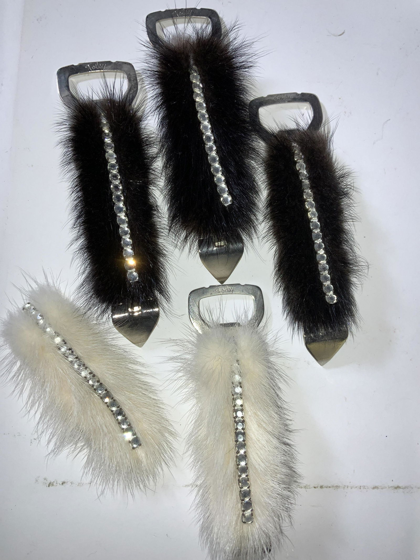 Lot 4 Foley Bottle & Can Openers w Mink Fur: Mid century Yellow Handle Celluloid Foley Bottle and Can Openers adorned with White or brown mink fur and rhinestone decor. 5.5 in long. Extra fur pelt. Property of Manhattan Estate. Foley bottle and
