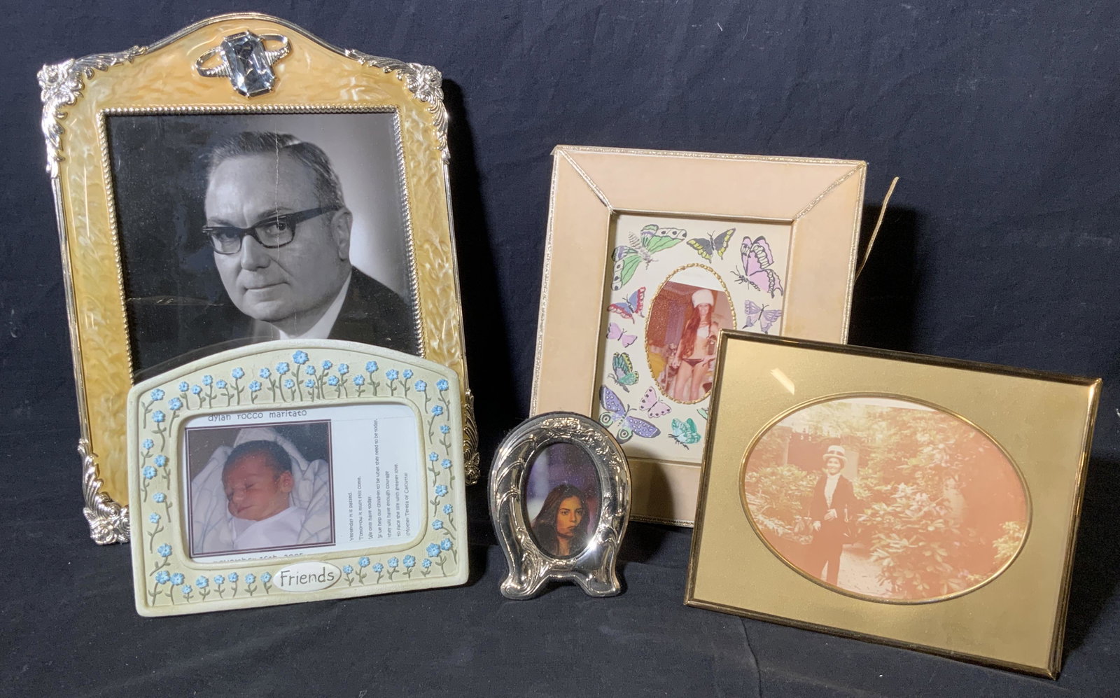 Group Lot 5 Picture Frames: Group lot 5 various picture frames, lot includes frames of ceramic metal and linens with velvet, all frames have some varying amount of wear or damage, largest of the frames measures 13.5 inches tall 