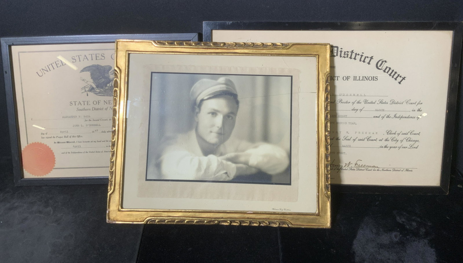 Lot 3 Wooden Picture Frames, Black & Gilt: Three rectangular/ square form frames for housing pictures. Two frames are black hued, crafted from wood. One frame is crafted from wood and painted with gilt. The frames have some losses, some cracks