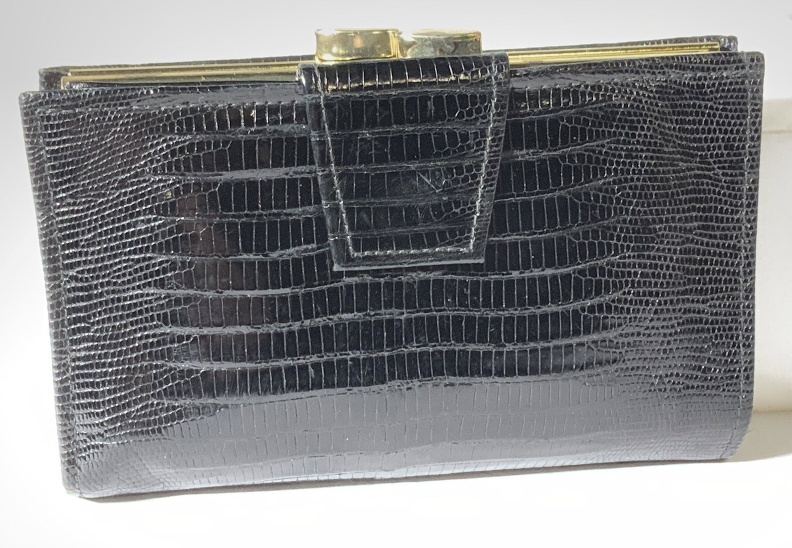 ST THOMAS ALLIGATOR LIZARD Ladies Wallet: Soft hand wallet, black, labeled Alligator lizard and marked St. Thomas. This wallet had a snap clasp over area for credit cards, papers or dollar bills. Deep side pocket for other paper money and sep
