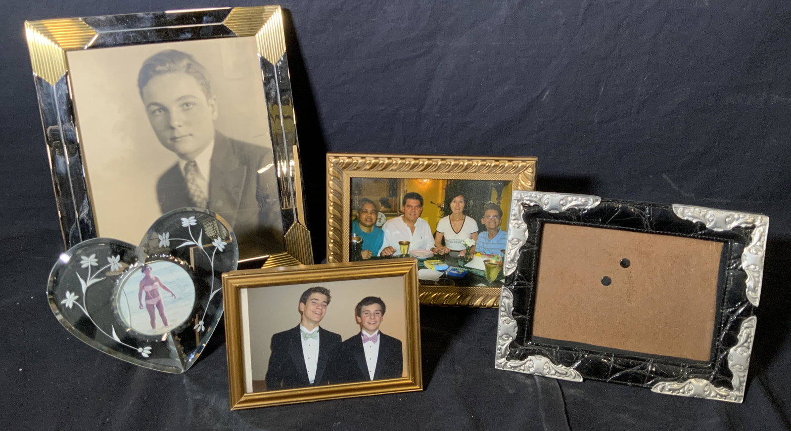 Group Lot 5 Picture Frames: Group lot 5 various picture frames, lot includes frames of wood metal leather and glass, all frames have some varying amount of wear or damage, largest of the frames measures 12 inches tall by 10 inch