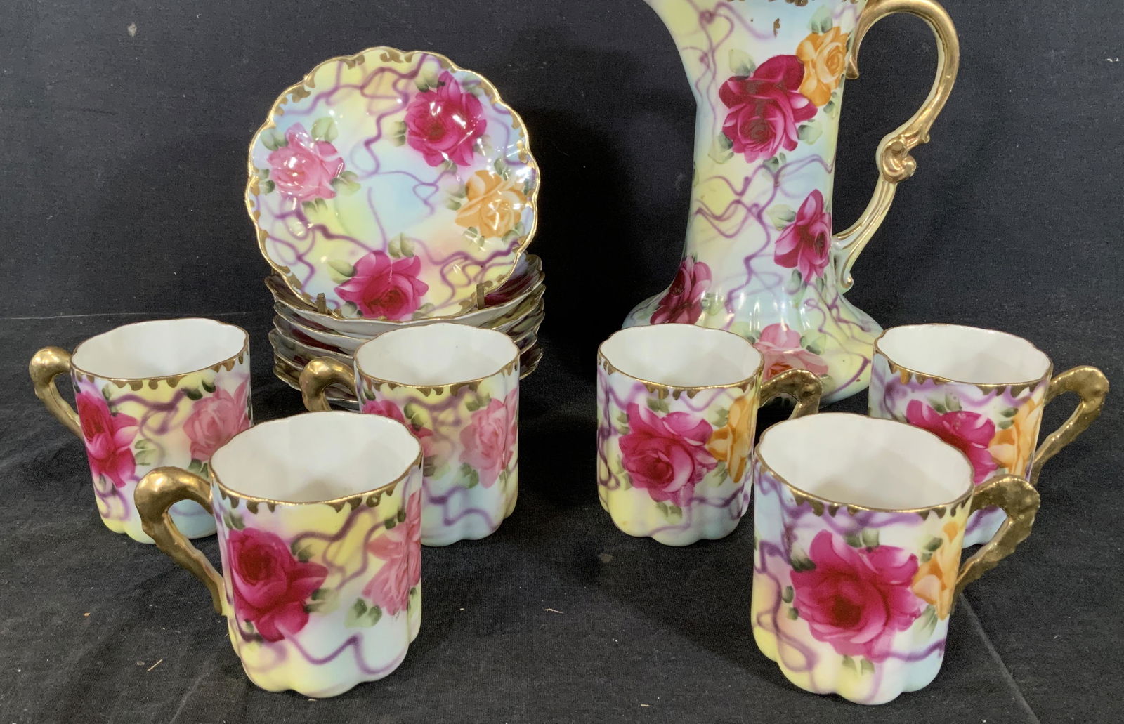 Set 13 Antique China Tea set, Japan: Lid to teapot is not included. Set 13 Antique China Tea set, Japan, stamp to base of teapot reads ‘Nippon Hand painted’, floral design with gilt rims and handles, teapot measures 8 5/8 inches tall