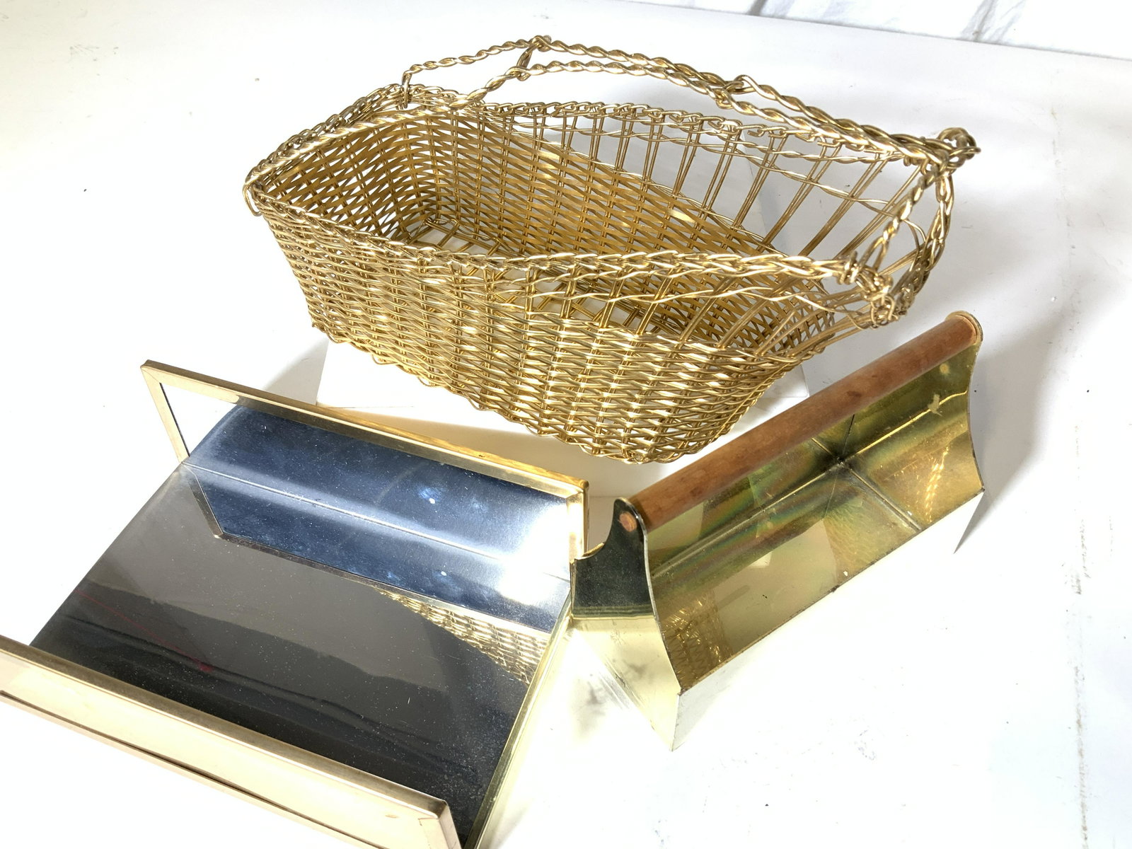 Lot 3 Tabletop Accessories Wine Pourer Basket more: Gold/ Brass toned Accessories Gold tone wire wine bottle basket, 10 x 4 in. brass toolbox. Reflective chrome and brass toned open container to hold tableware supplies, candles, more. Property of Manha