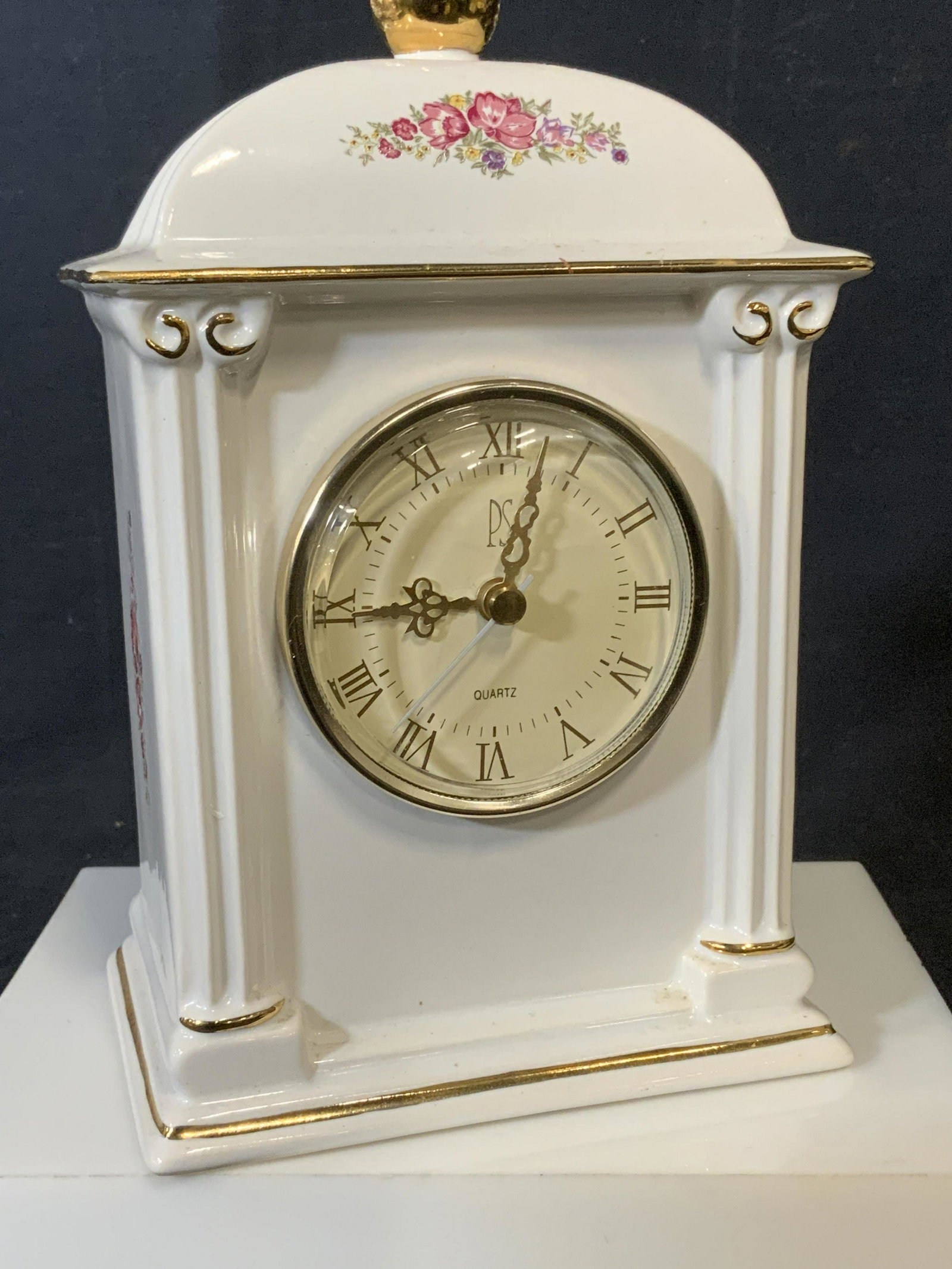 PAUL SEBASTIAN limited edit Porcelain Mantel Clock: 1993 Paul Sebastian Limited Edition Battery Operated Ceramic Mantel Quartz Clock, measuring approximately 5-1/4 in. L x 3-9/16in. W x 8in. H. Gilt ball finial tops clock. Hand painted florals on sides