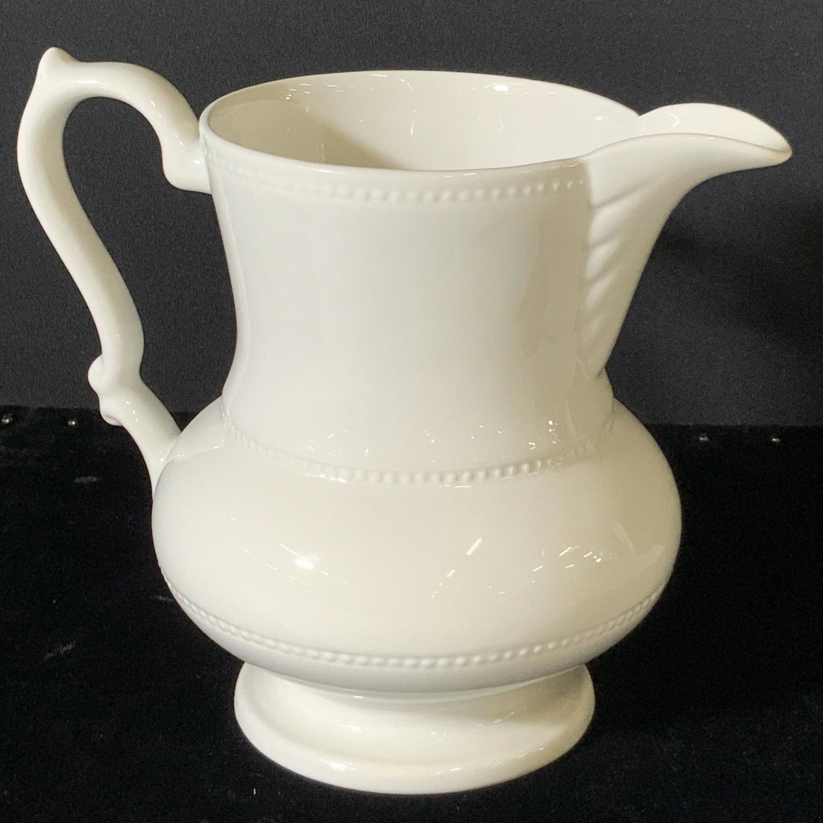 Vintage LORD NELSON Pottery Pitcher, ENGLAND: Vintage ironstone LORD NELSON pottery pitcher. Stamp on underside has Lord Nelson crown symbol and reads: Lord Nelson Pottery England 7-76. Pitcher is white with embossed dot design and scalloped desi