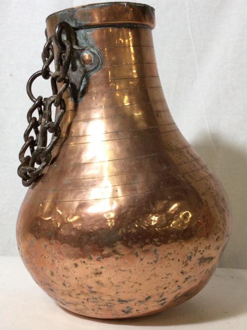 Primitive Antique Gourd COPPER Jug: Pitted & Hammered copper jug, iron hanging chain and hook attached to loop handles. Shape of a Gourd. 13.5 in ht, 10 in width, plastic water cup inserted in Collar. Hangs 12 in. Large hook. Minor oxid