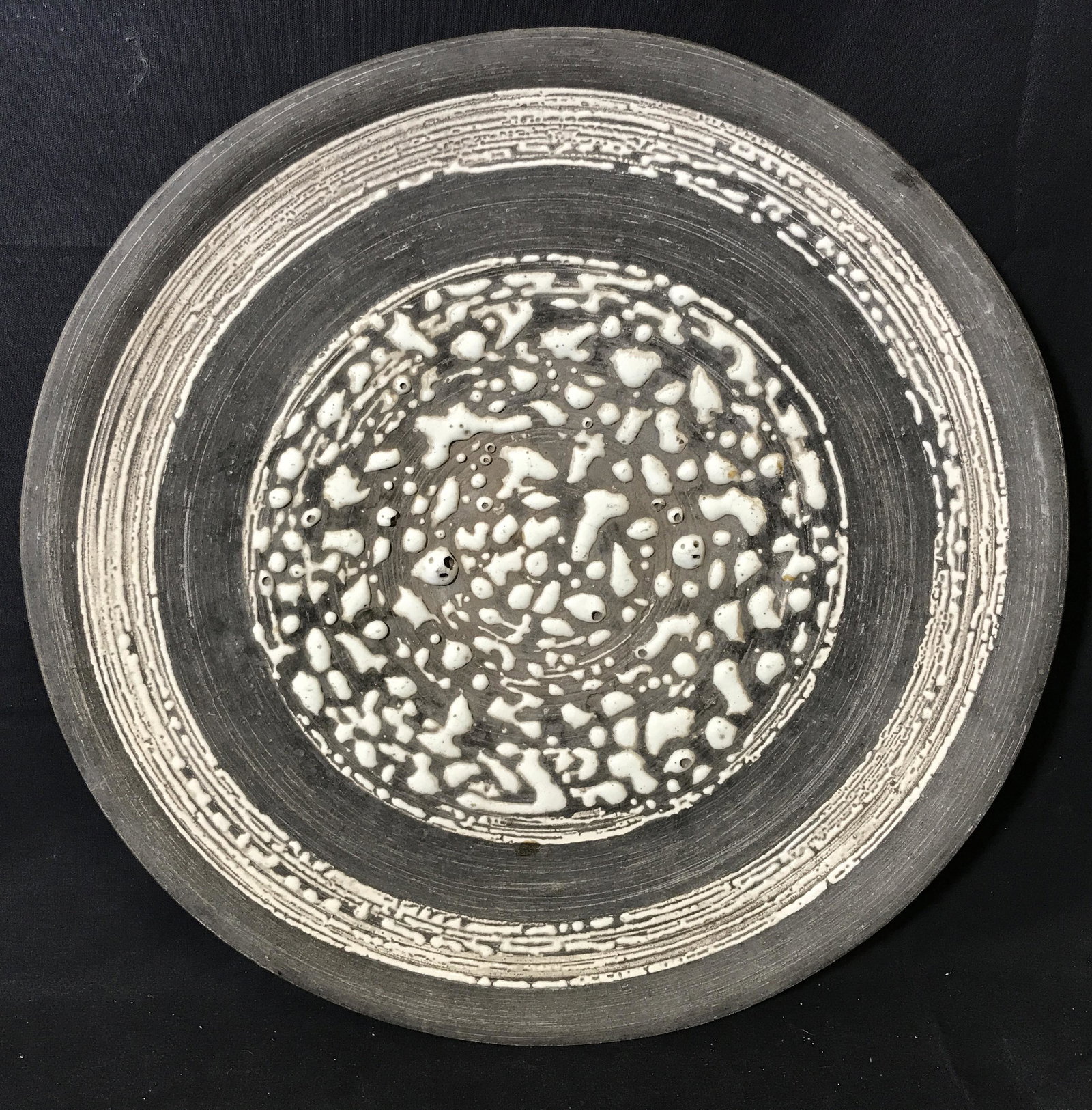 Signed Phyllis Lester Decorative Ceramic Dish: Signed decorative ceramic bowl, signature on the bottom reads ‘Phyllis Lester California’, dish painted grey an unglazed with white bubble glazing, measures 16.5 inches in diameter, dish in good c