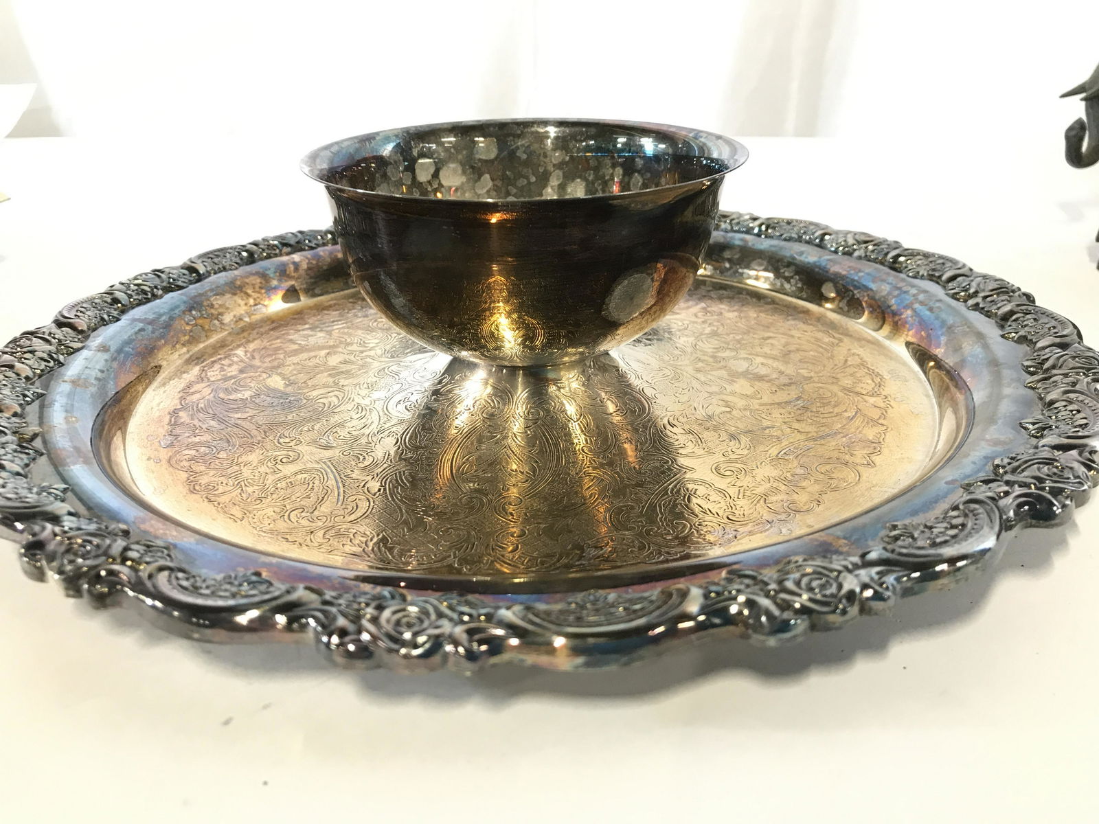 Oneida Etched Victorian Plated Serving Platter: Scroll and rose embossed rim platter with attached dipping bowl. Hallmarked ONEIDA USA. PLATED base metal, possibly silver plated, heavy tarnish. Center heavily etched Reticulated pattern. App 3 in Ht